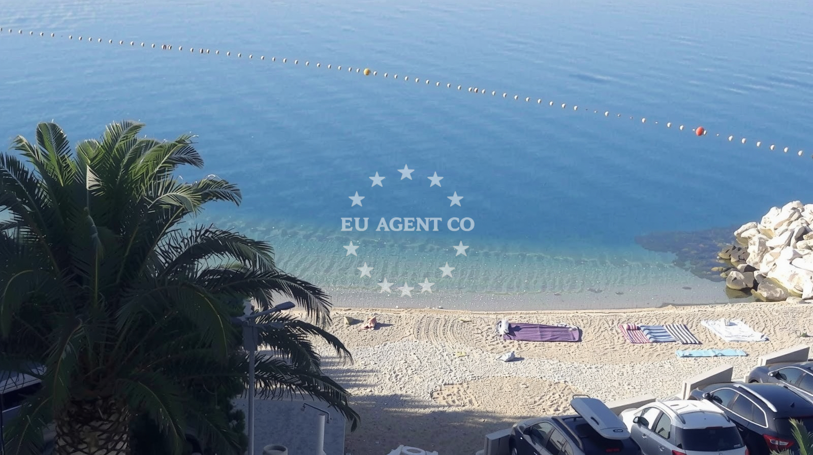 View of Tekla Point with hotels and shingle beach from Caklje Harbour