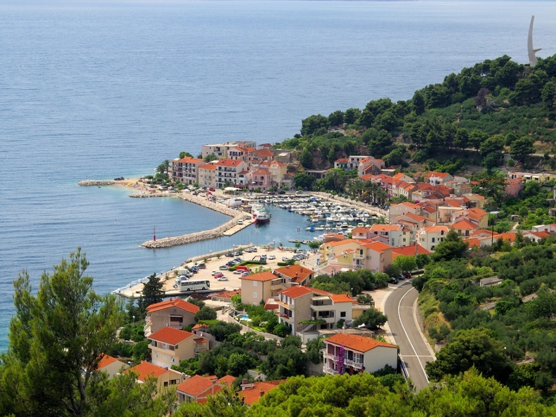 Podgora Harbour with Seagull's Wing monument in the background