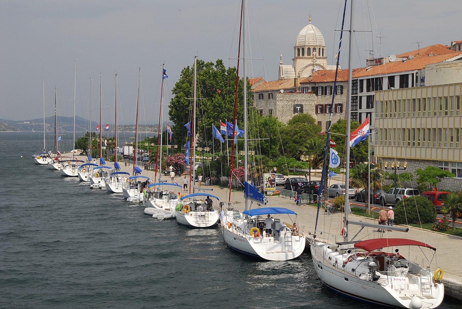 Šibenik Harbour quay with yachts moored alongside the old town.