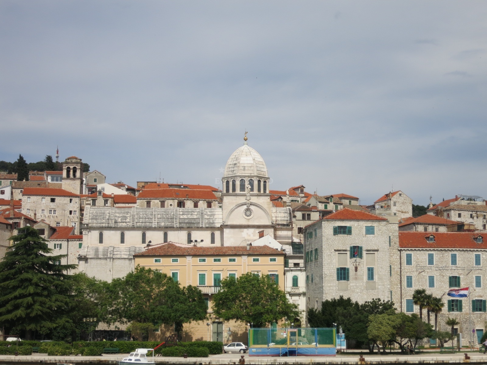 Šibenik Harbour at sunset with the old town and cathedral visible.