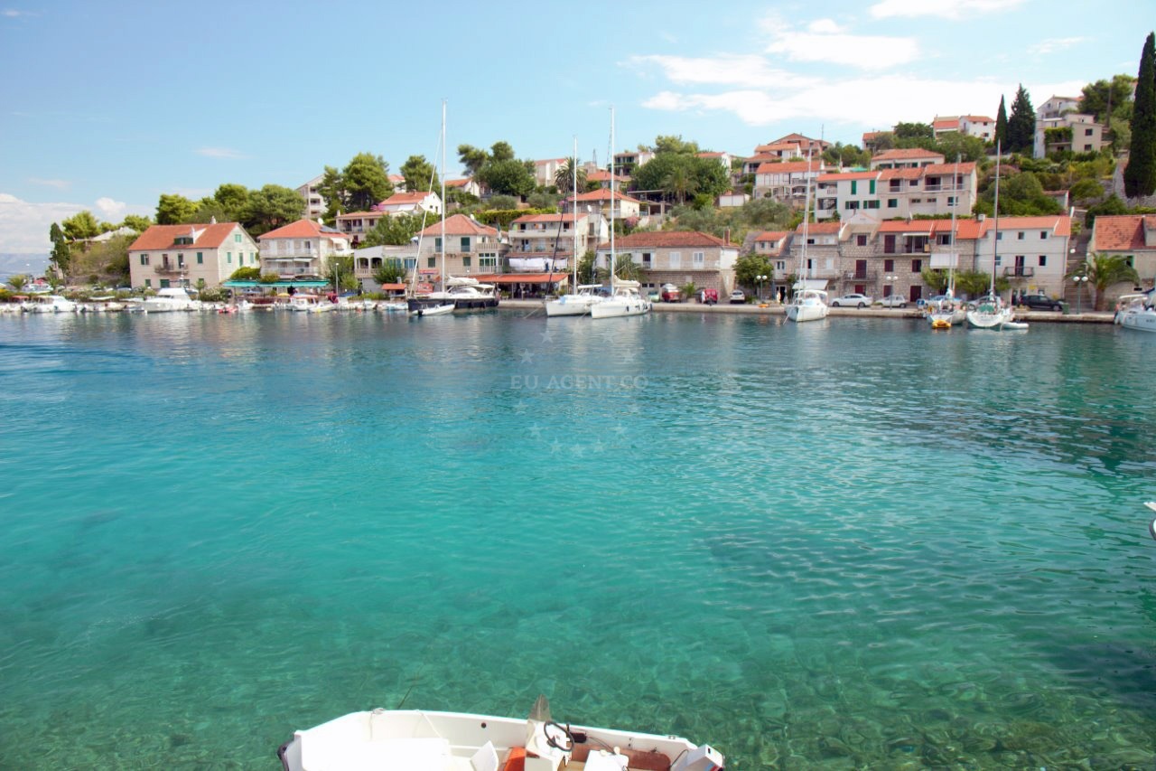 Stomorska Harbour, Šolta Island, Croatia - Panoramic view of the harbor with nearby cafes and taverns along the waterfront.