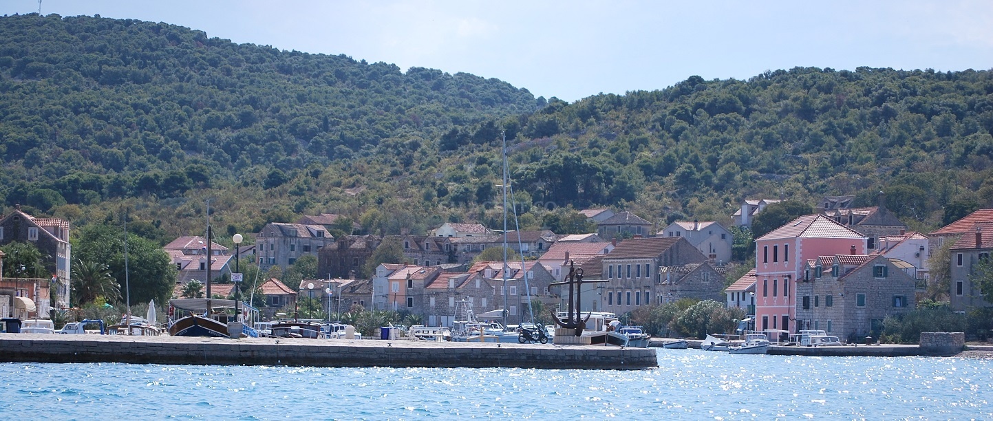Zlarin Harbour with breakwater and moored yachts