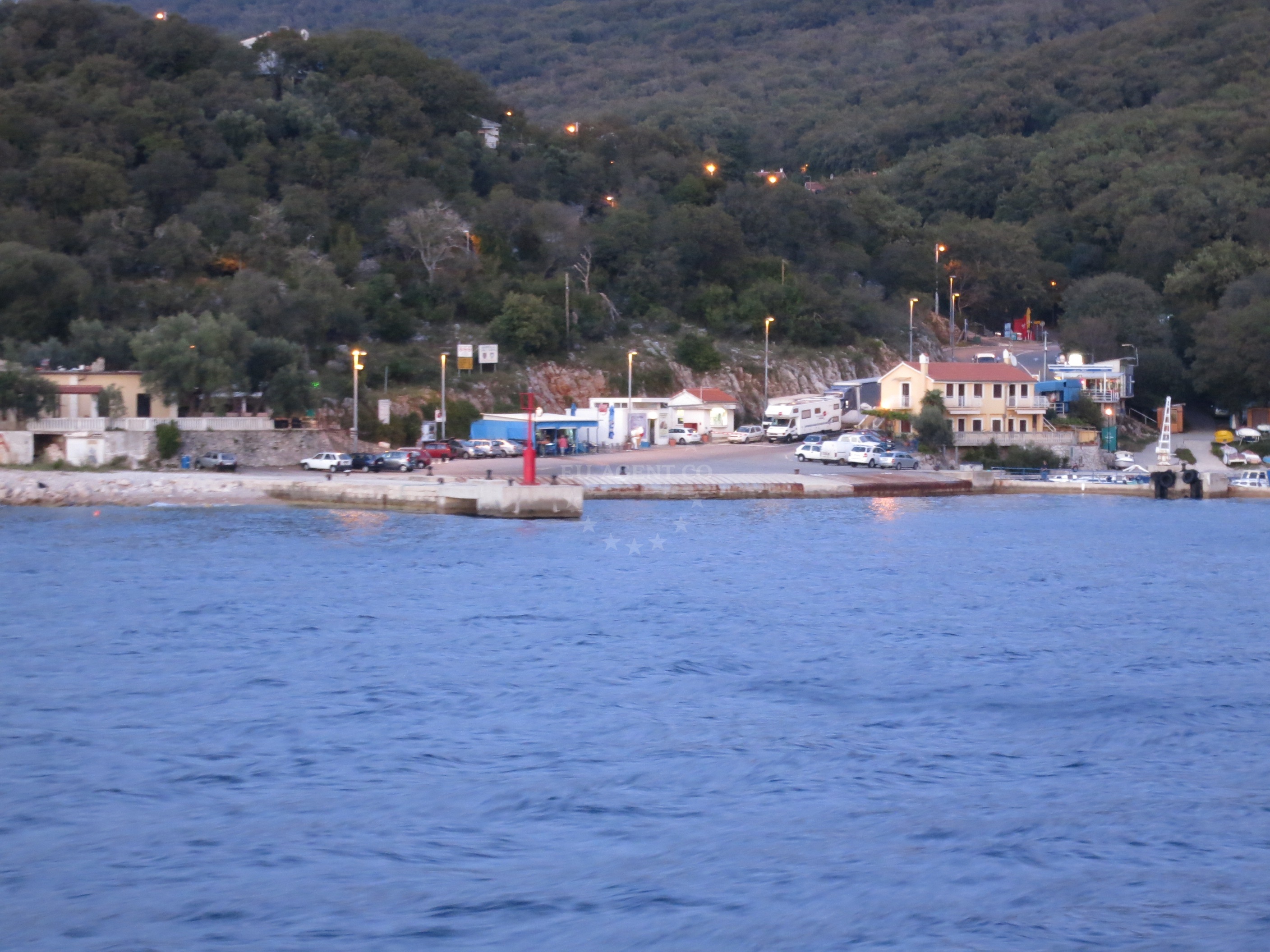 Porozina Harbour on Cres Island with village houses and jetty