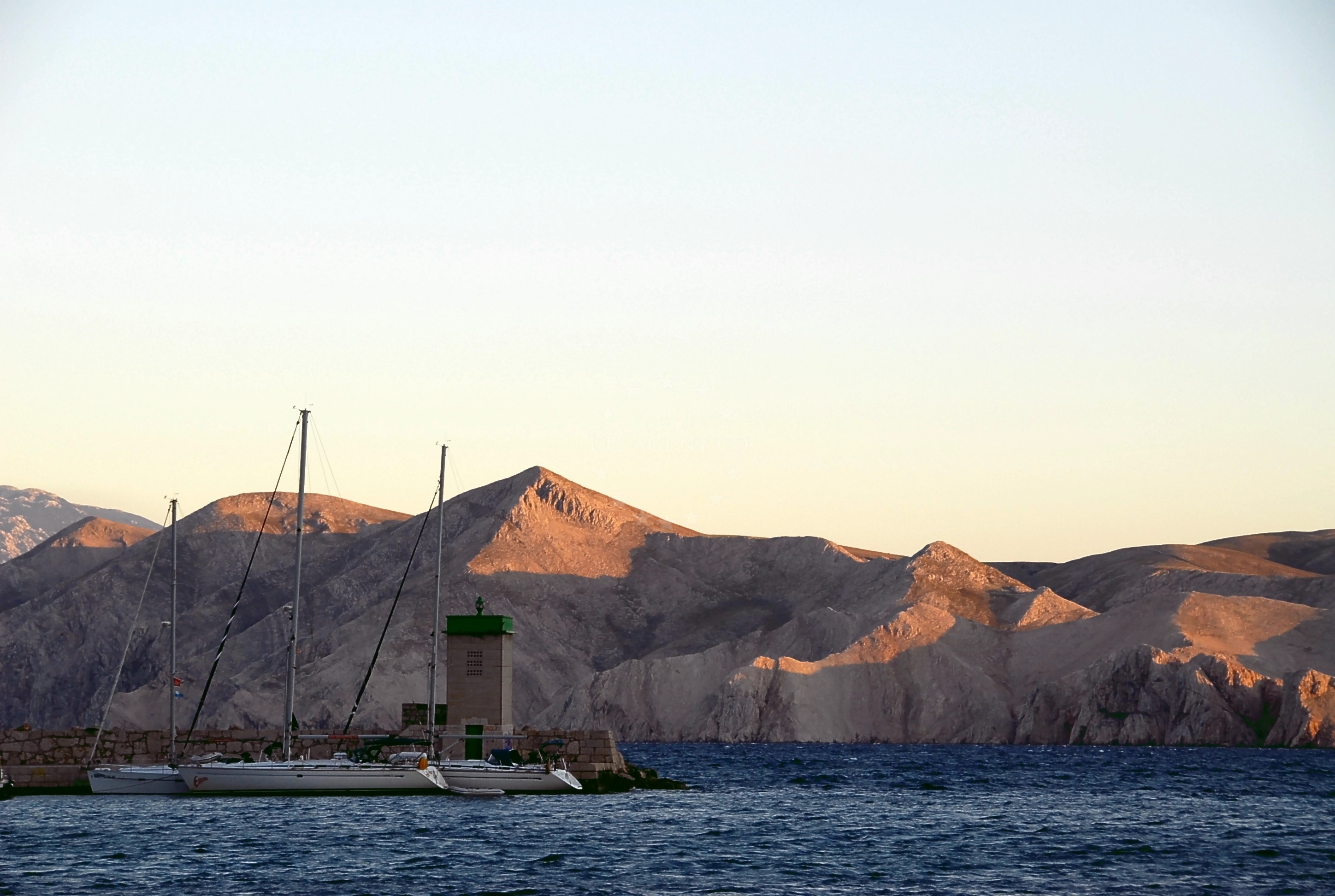 Sailboats berthing at Baska Harbour