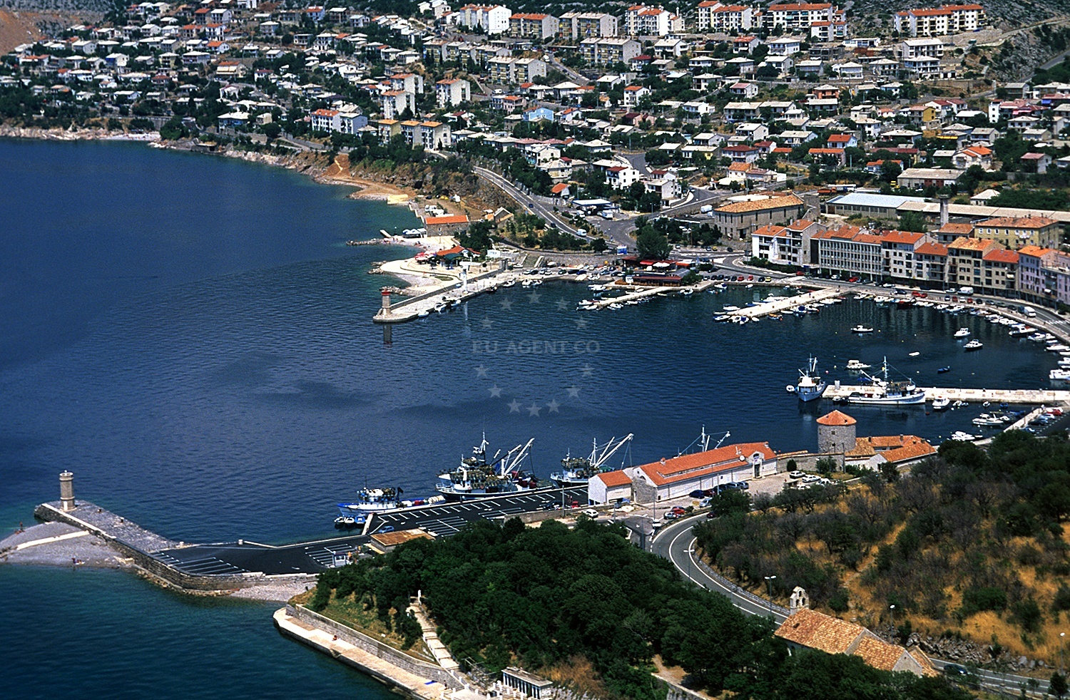 Senj Harbour with lighthouses and the fortress of Nehaj in the background.