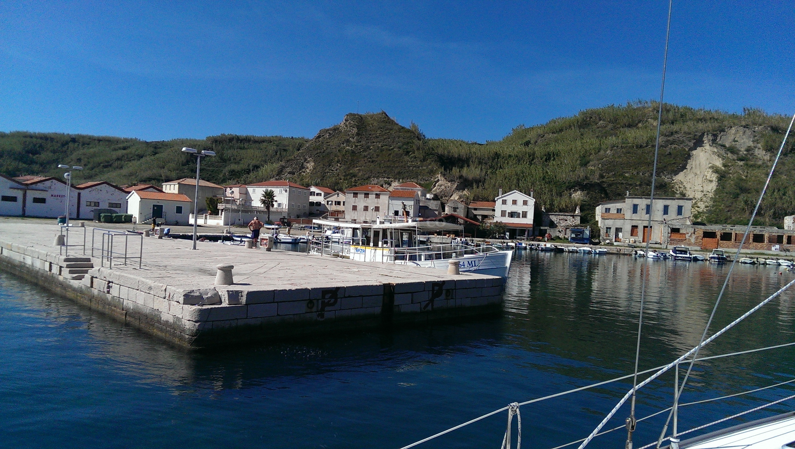 Car-free Susak island with yachts moored at the east jetty