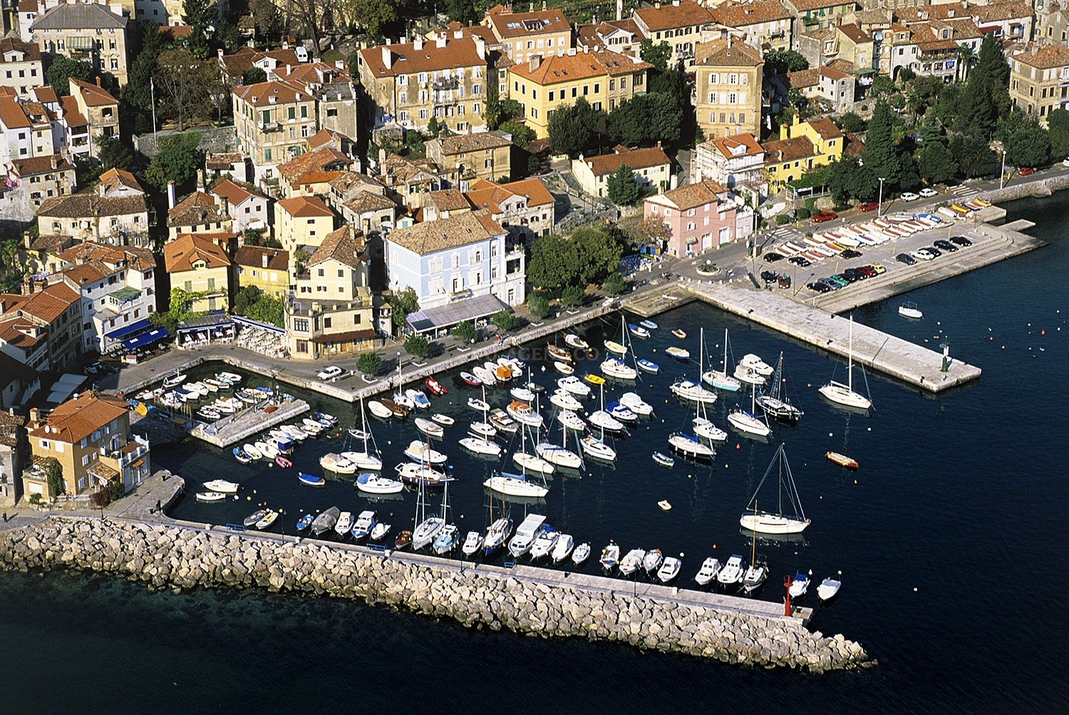 Volosko Harbour with historic church and boats moored nearby
