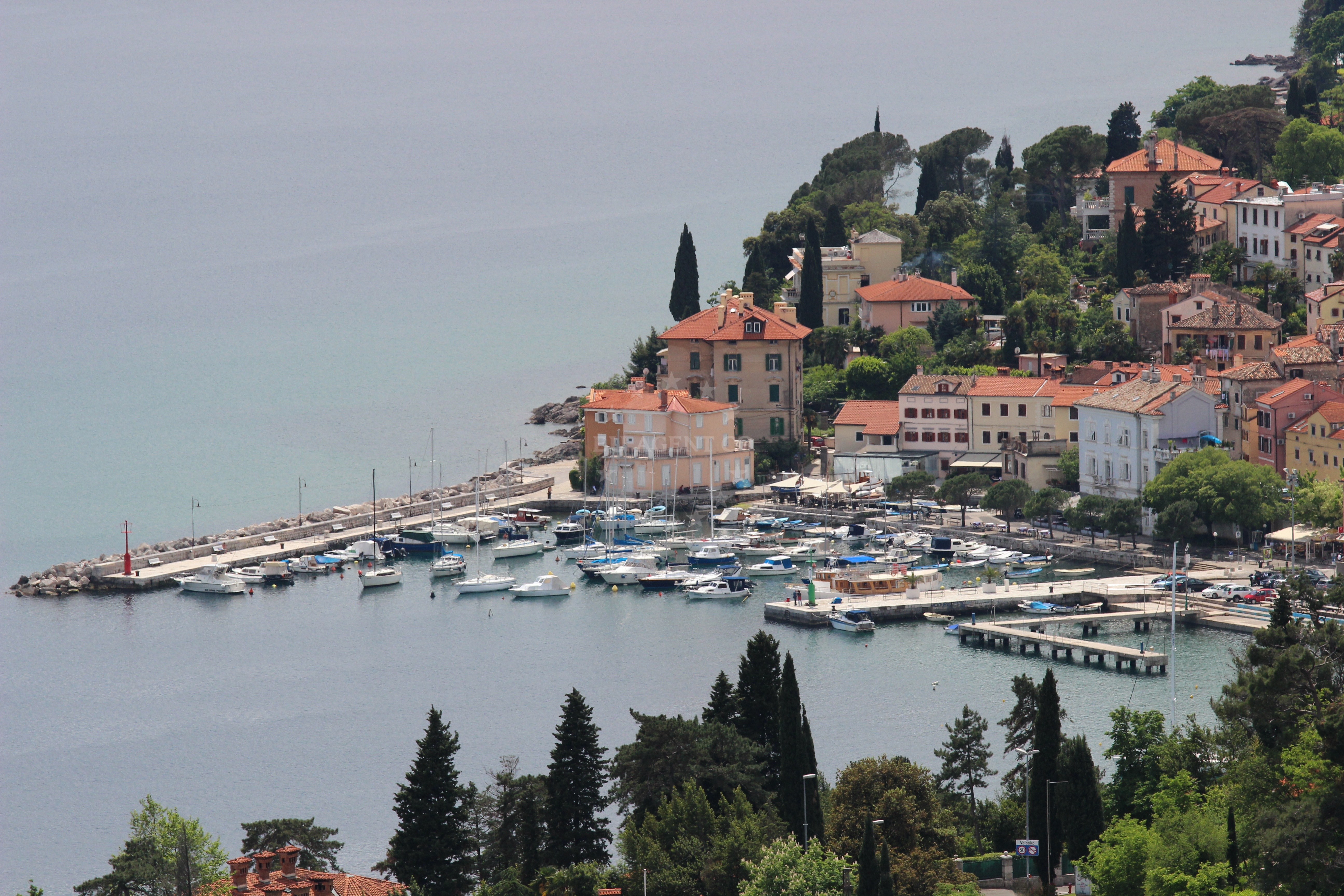 View of Volosko Harbour from the water with surrounding coastal landscape