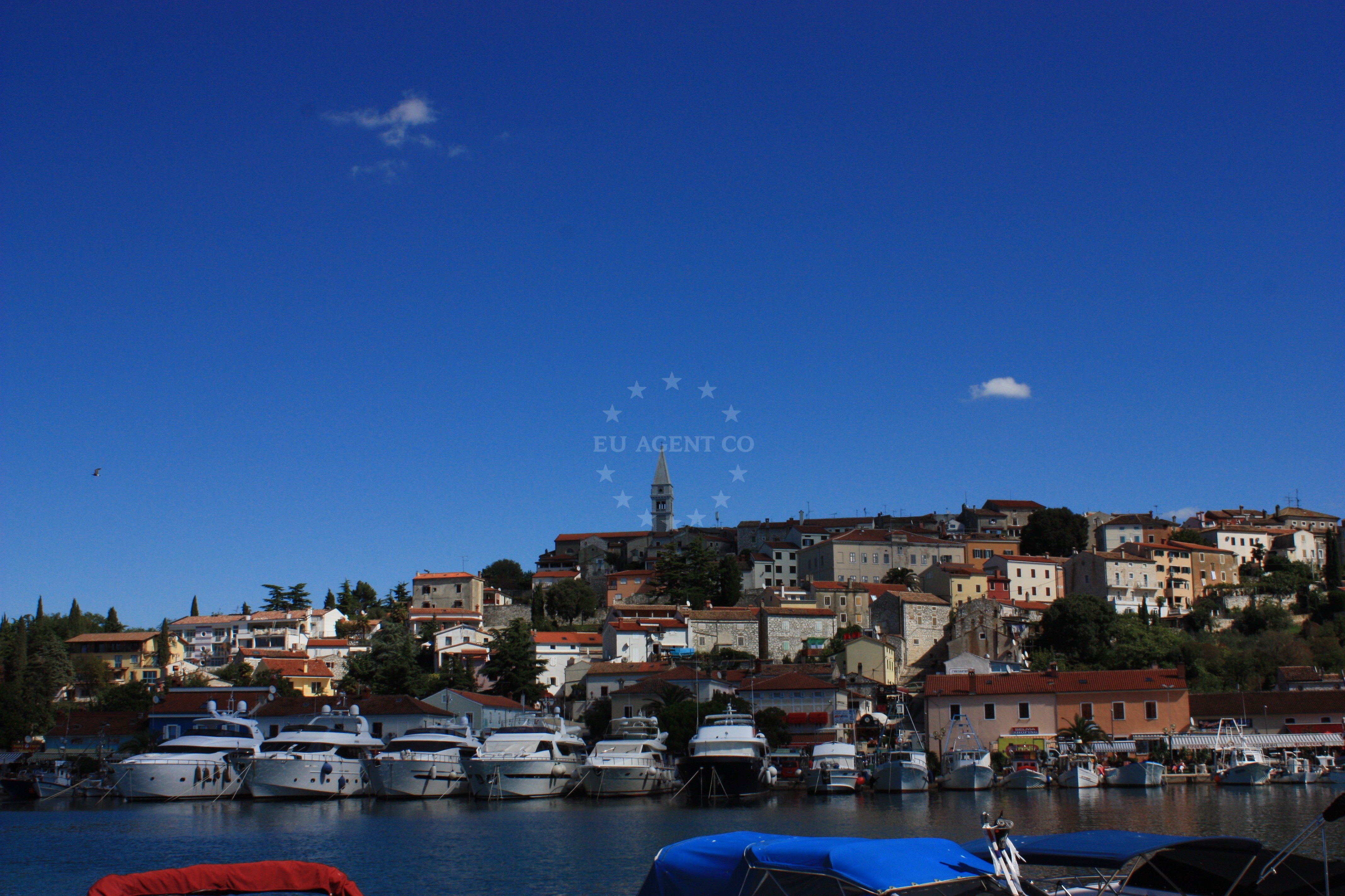 Vrsar Harbour with yachts moored near the bell tower