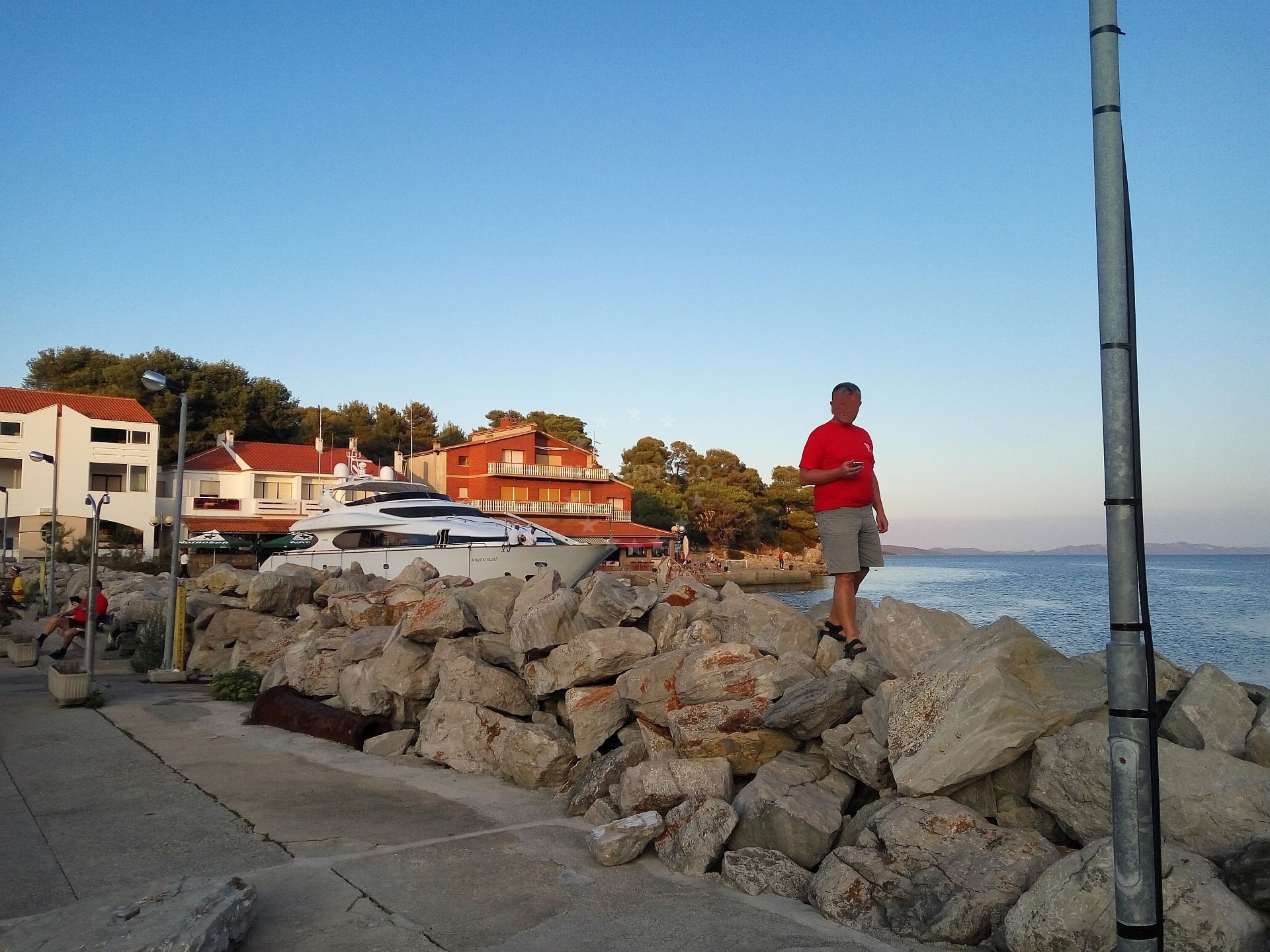Yacht berthing at Bozava Harbour with nearby restaurants