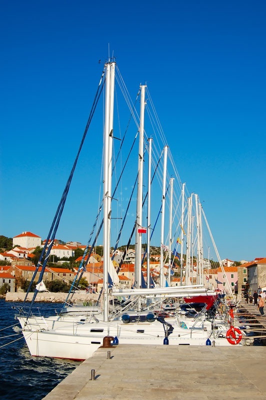 SW quay of Sali Harbour with mooring lines and sardine factory