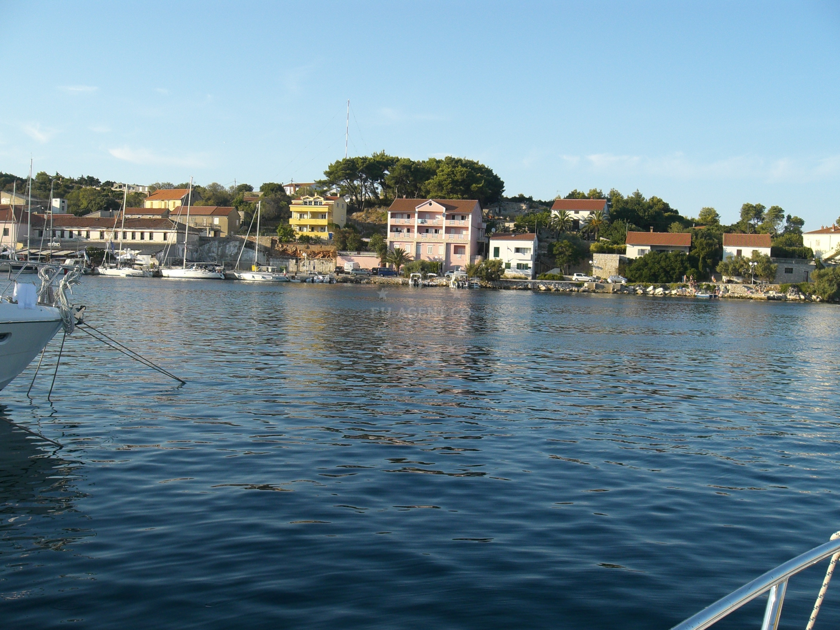 Sali Harbour with village bell tower and breakwater