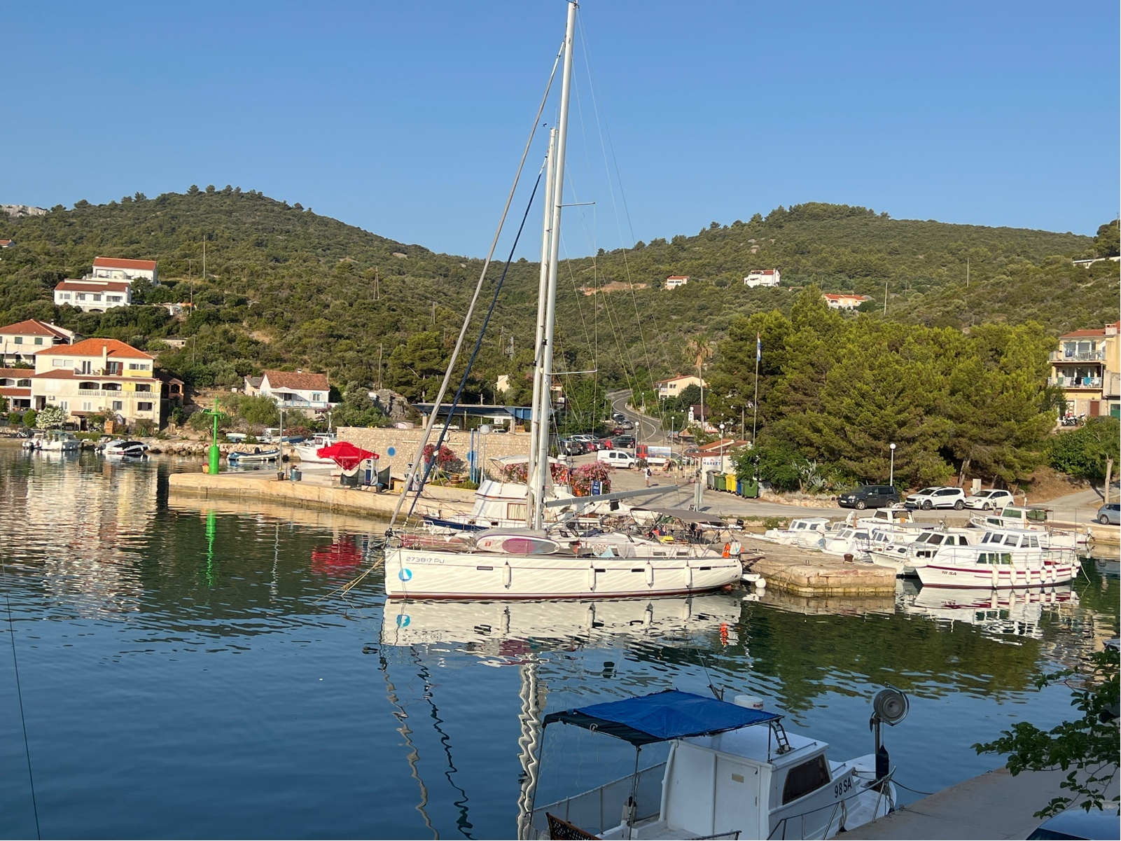 Zaglav Harbour with moored yachts and the breakwater