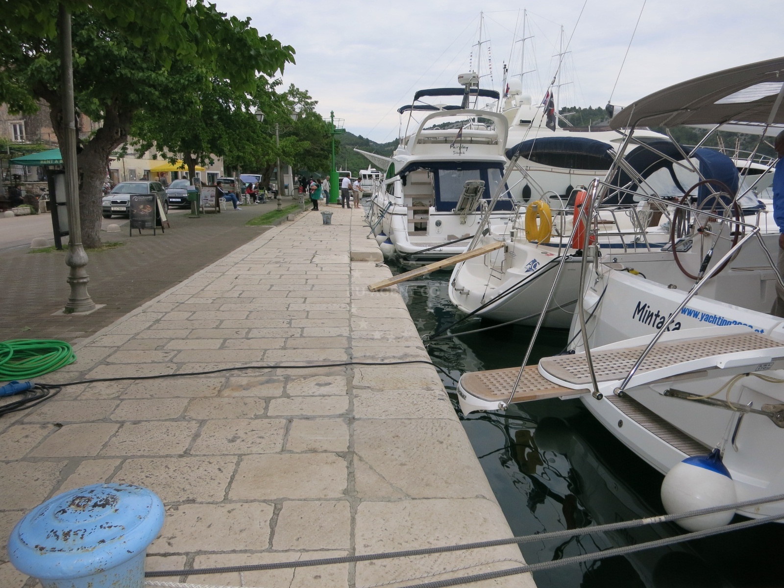 Skradin Harbour public quay with stern-to mooring lines.