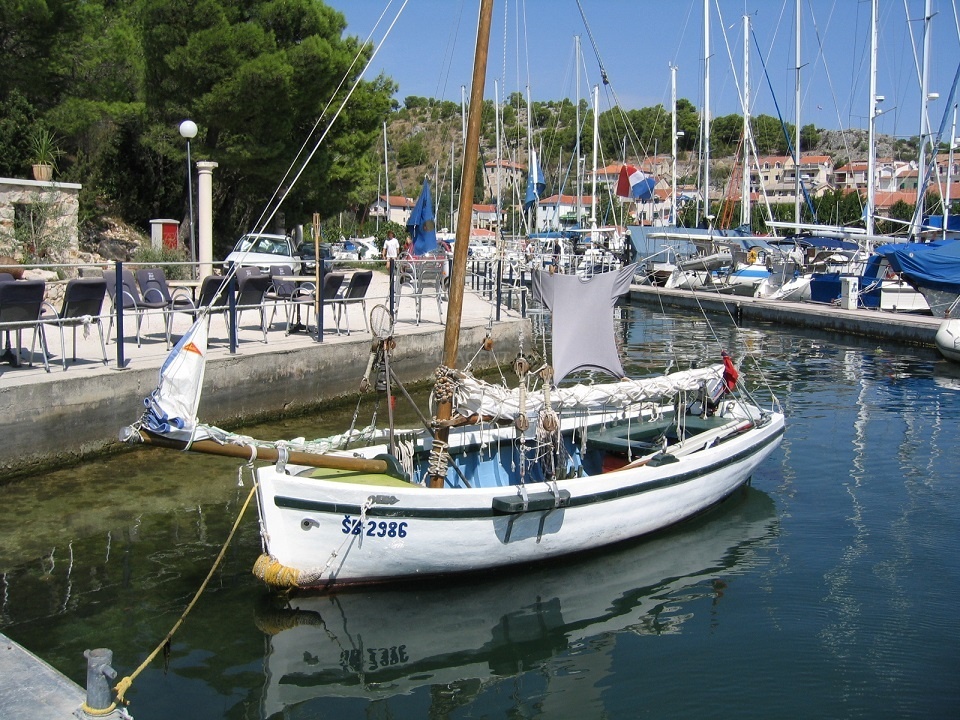 View of Skradin Harbour with mooring lines near the hotel complex.