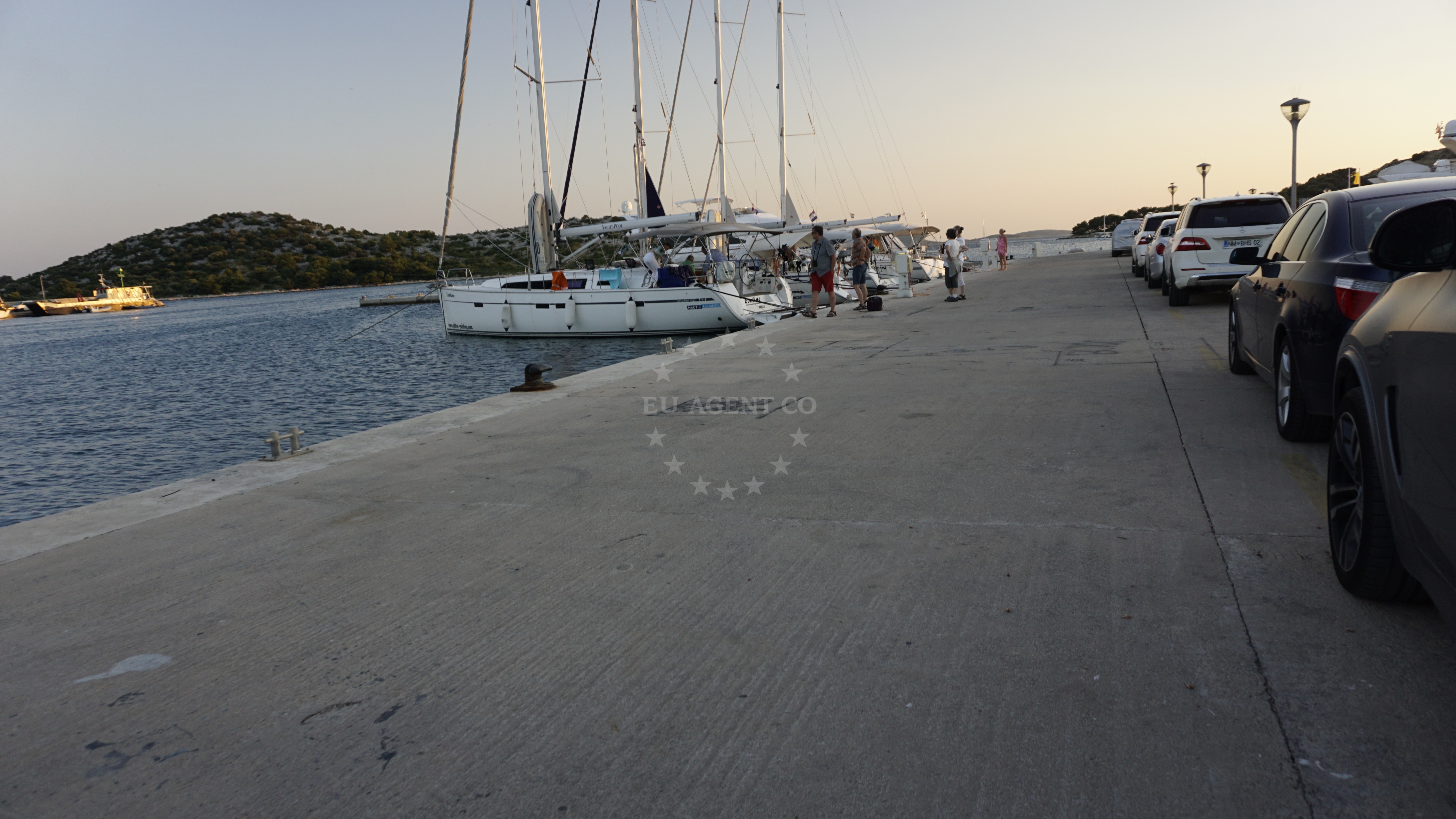 Tribunj Harbour at sunset with nearby beaches visible