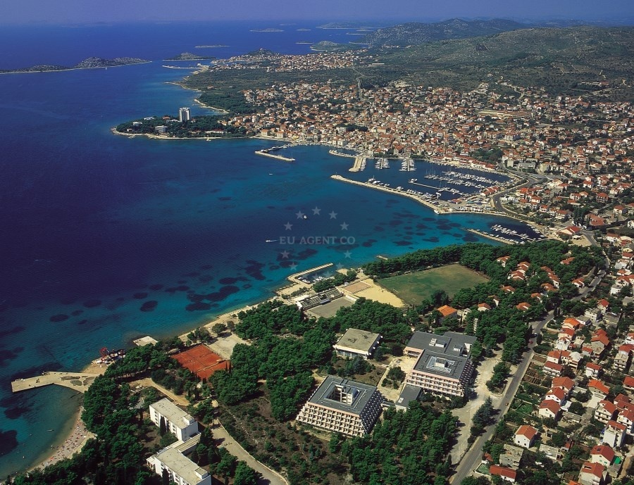 Vodice Harbour with moored yachts, historic town buildings, and the Adriatic Sea in the background