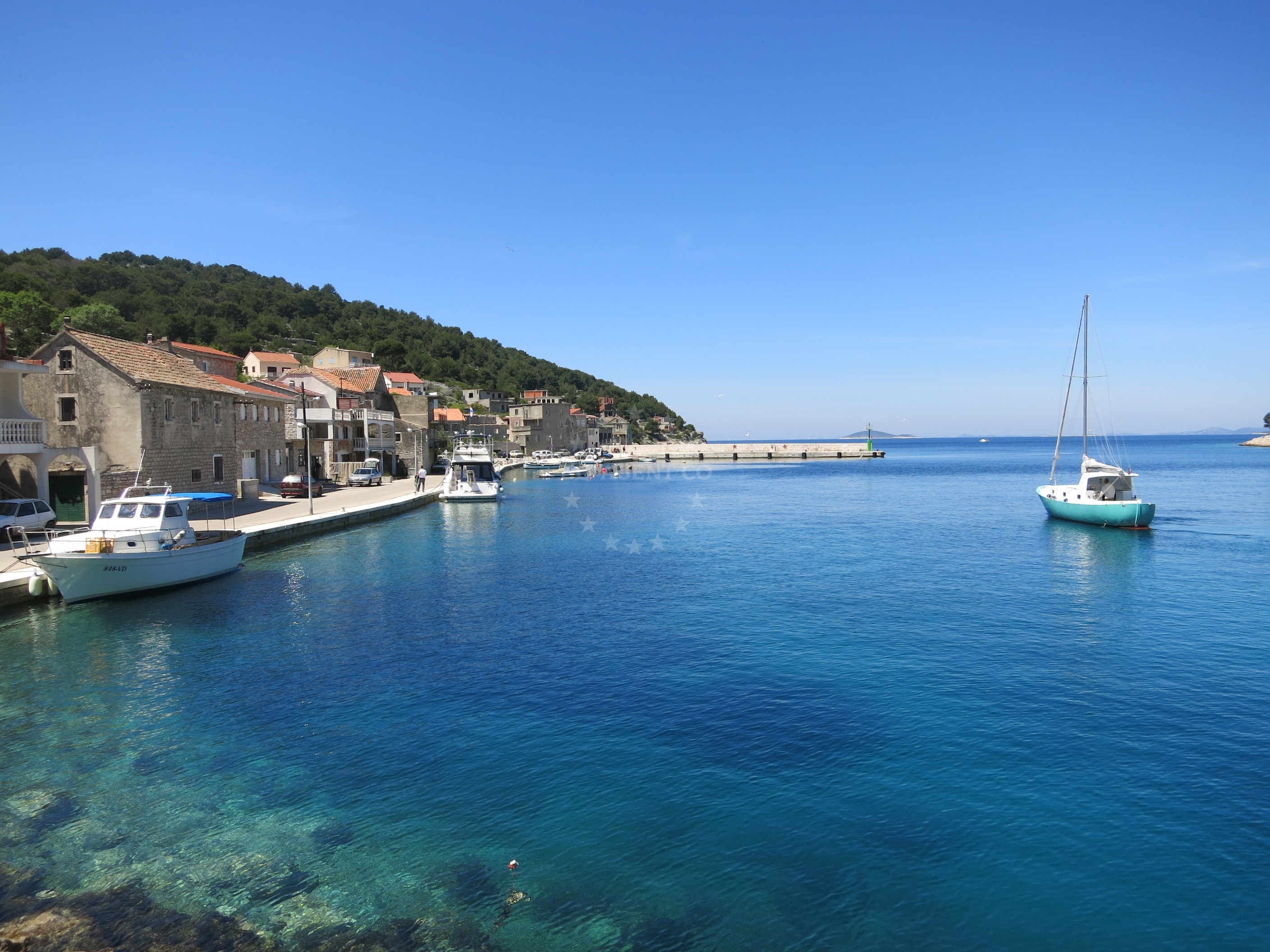 Muna Harbour quay with moorings and local boats