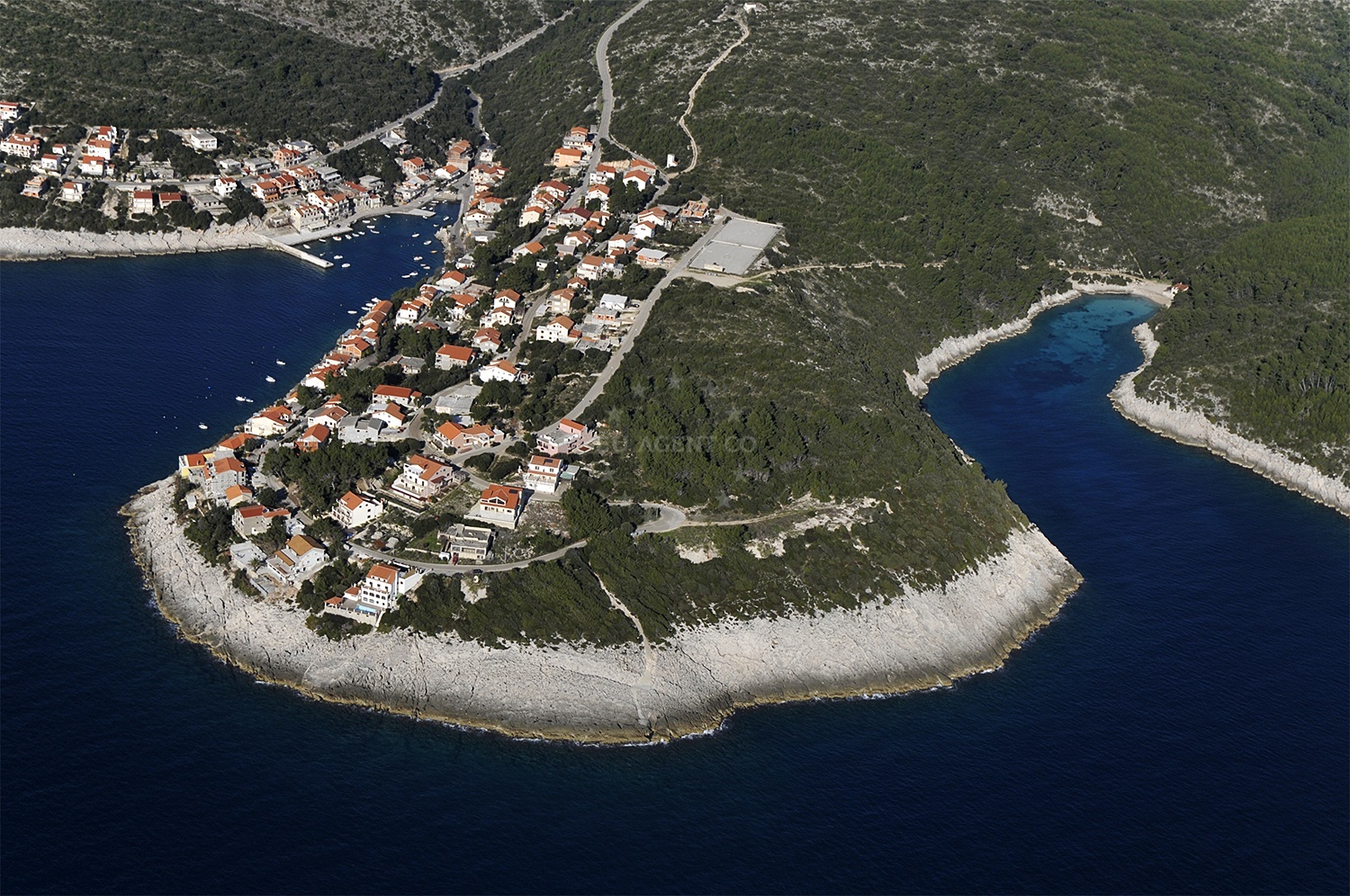 Harbor entrance with navigational markers and Korčula coastline