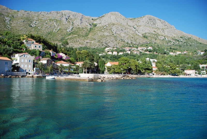 Yachts moored at Mlini Harbour with Srebreno Beach visible in the distance