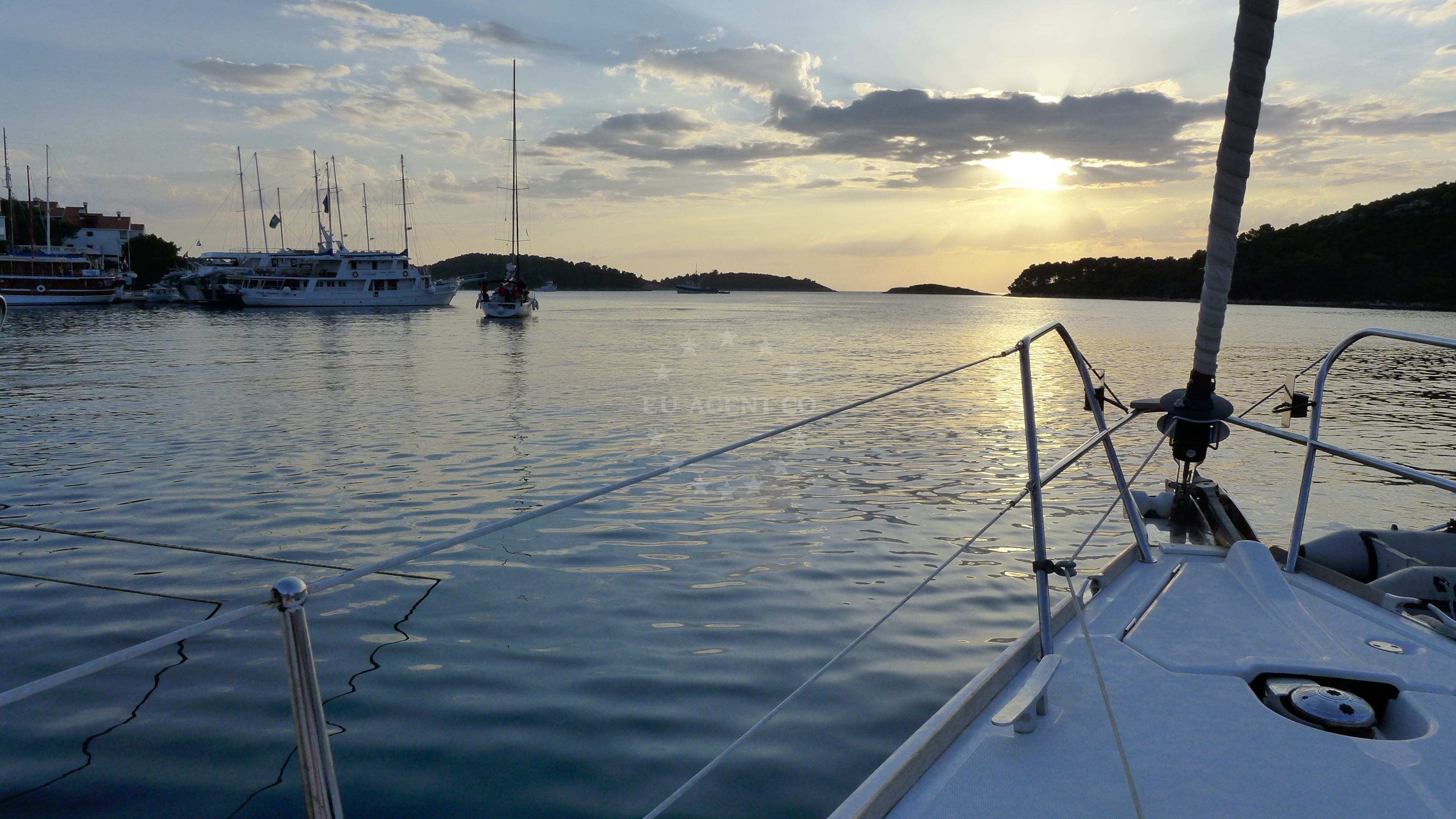 Pomena Harbour, Mljet Island, Croatia - village with pine trees and boats in the distance
