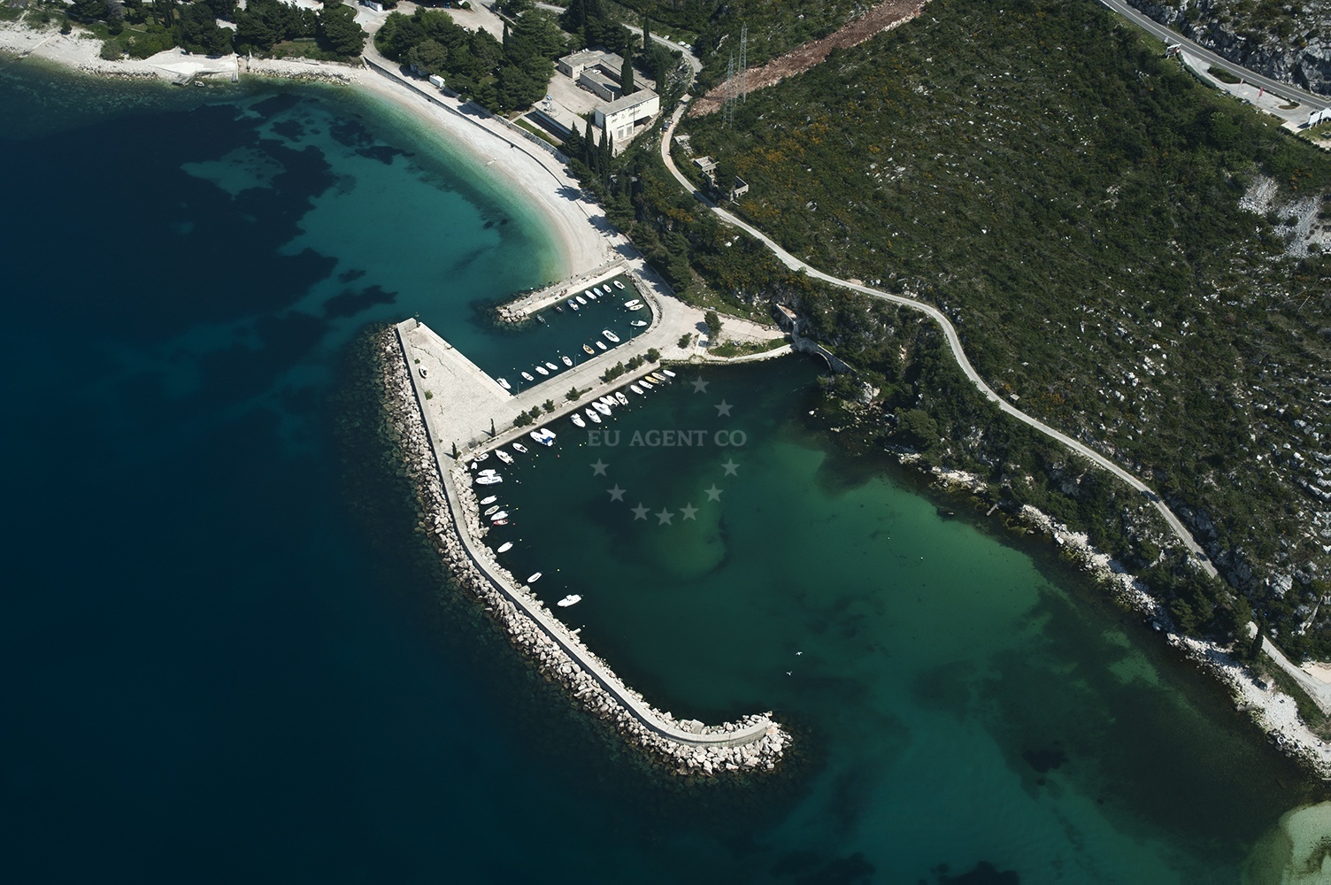 Plat Harbour with breakwater and traditional fishing boats in South Dalmatia, Croatia