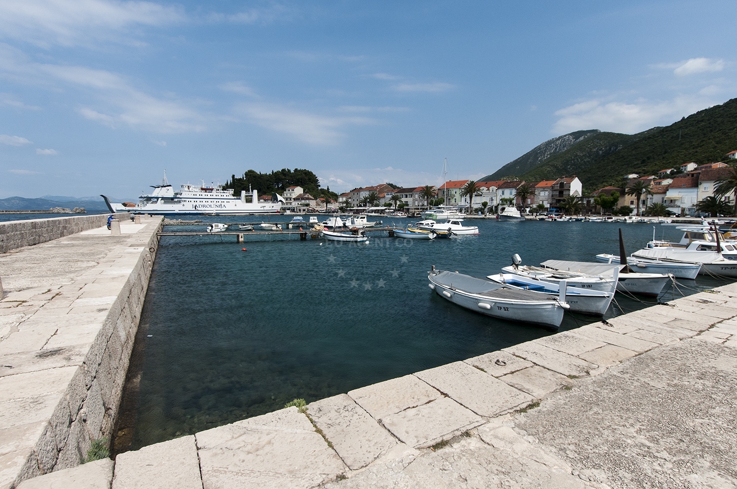 Trpanj Harbour with breakwater and Madonna statue