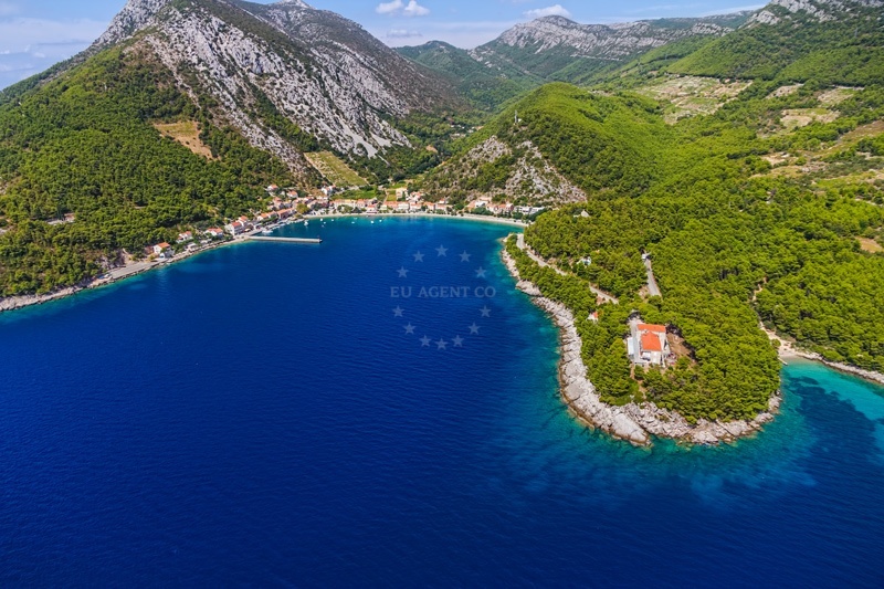 Yachts moored at Trstenik Harbour with scenic views of Žuljana Bay.