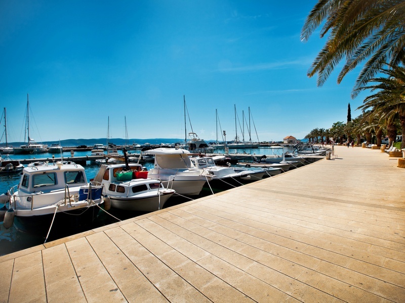 Marina Baska Voda with boats and the Biokovo mountain range in the distance