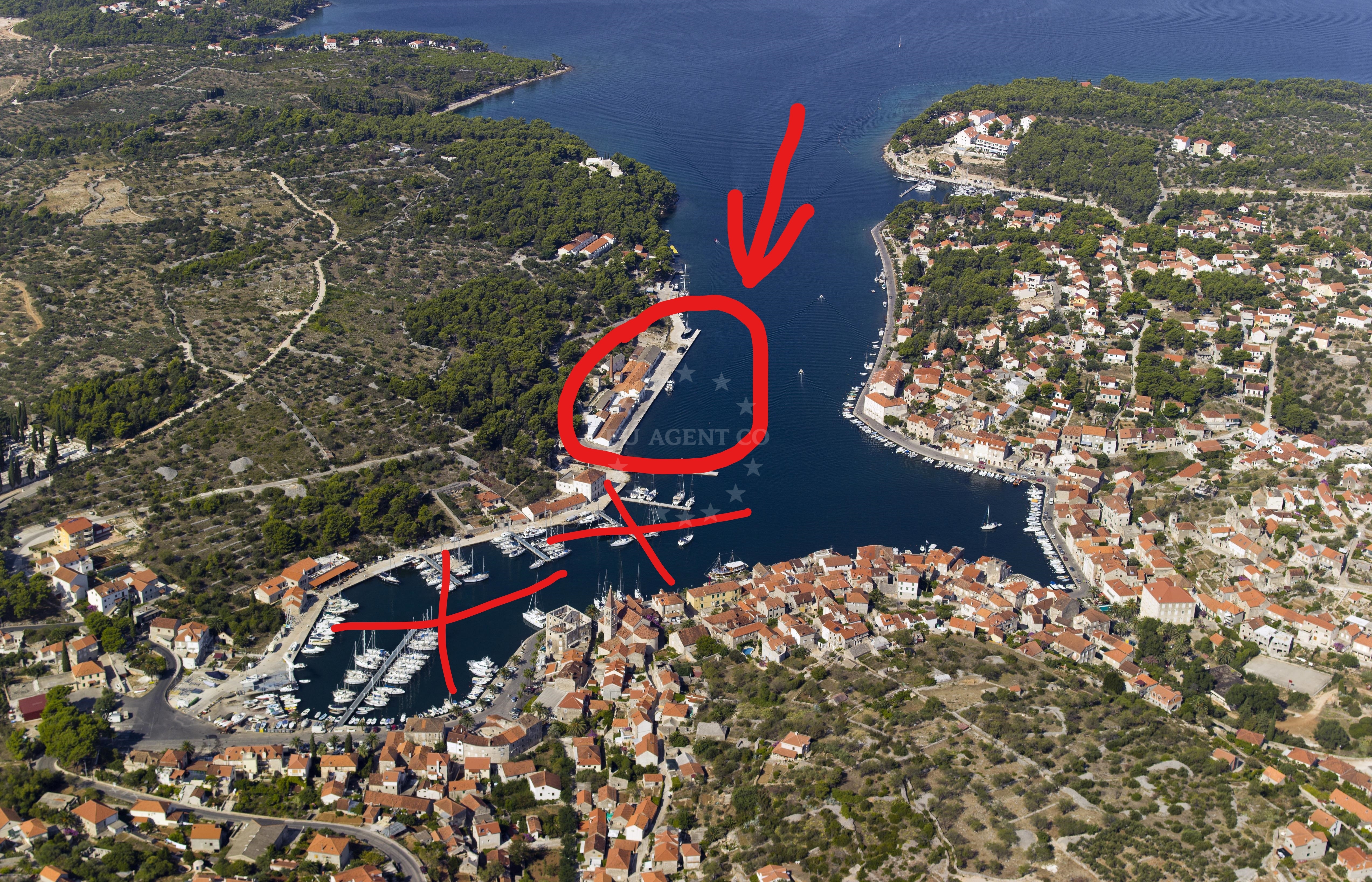 Marina Milna Kanarija, Brač: Moorings and boats in the marina with the island of Brač in the background.