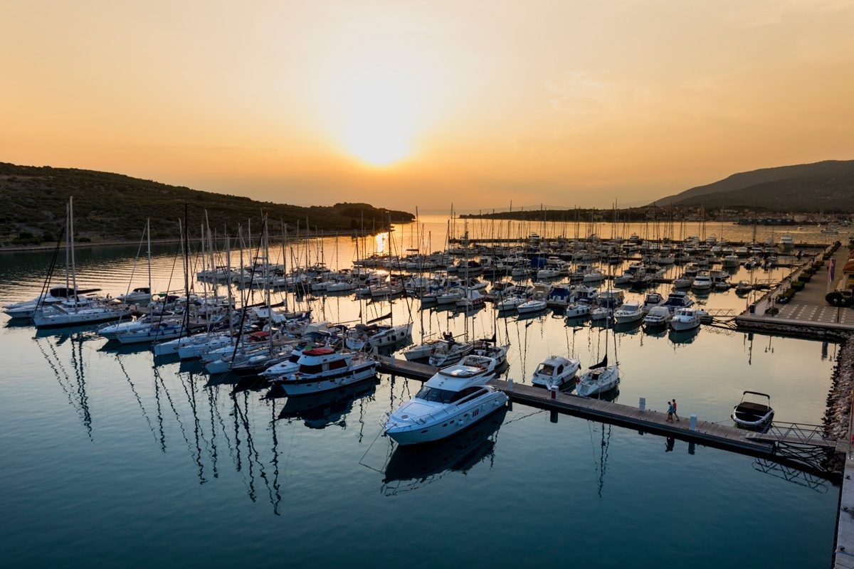 Marina entrance with harbor lights and breakwater