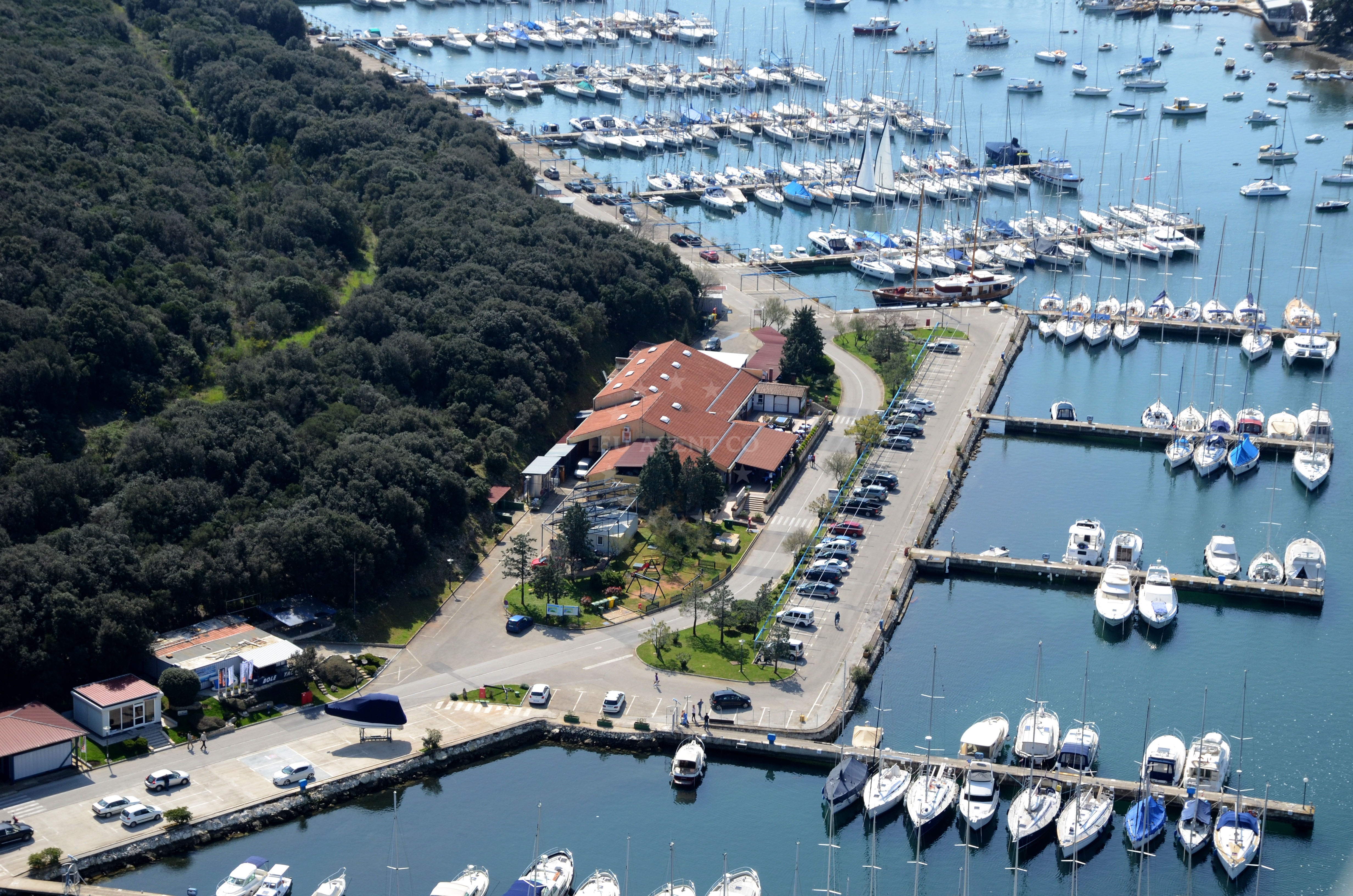 Marina Veruda's berths with yachts moored in a sheltered bay near Pula, Croatia