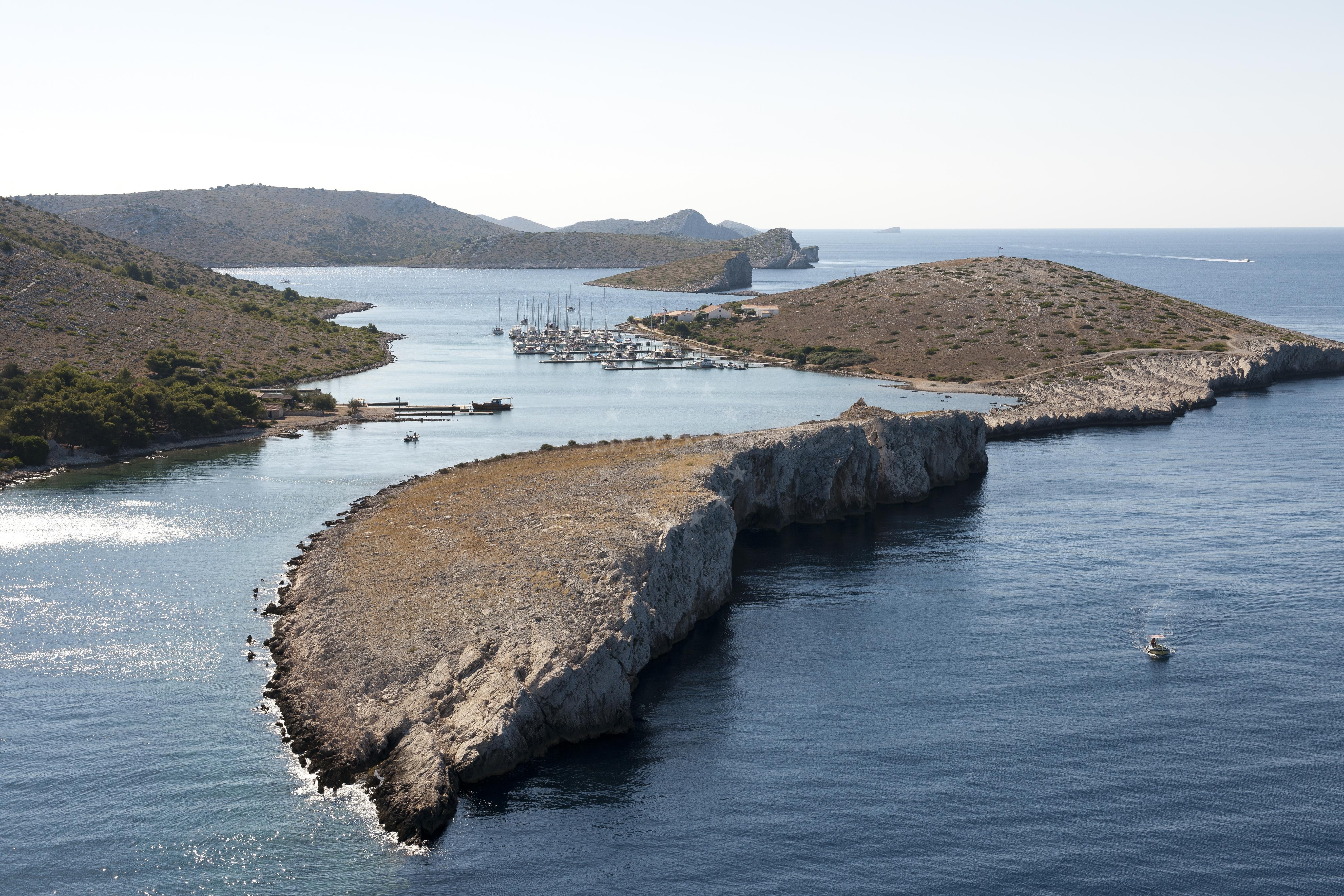 Boat docking at ACI Marina Piskera with Kornati archipelago in view