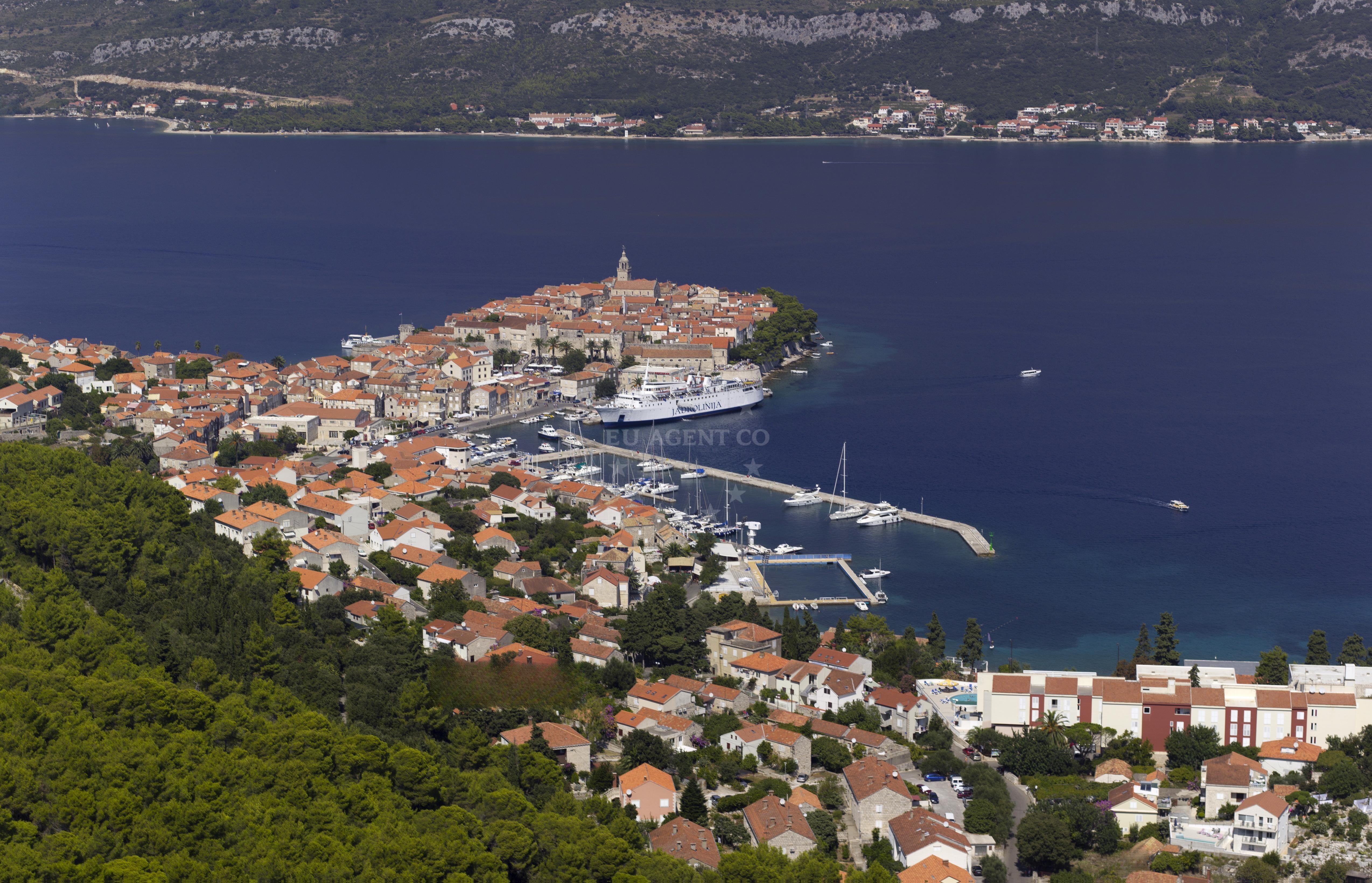 Yachts anchored near the marina with Lastovo island in the distance
