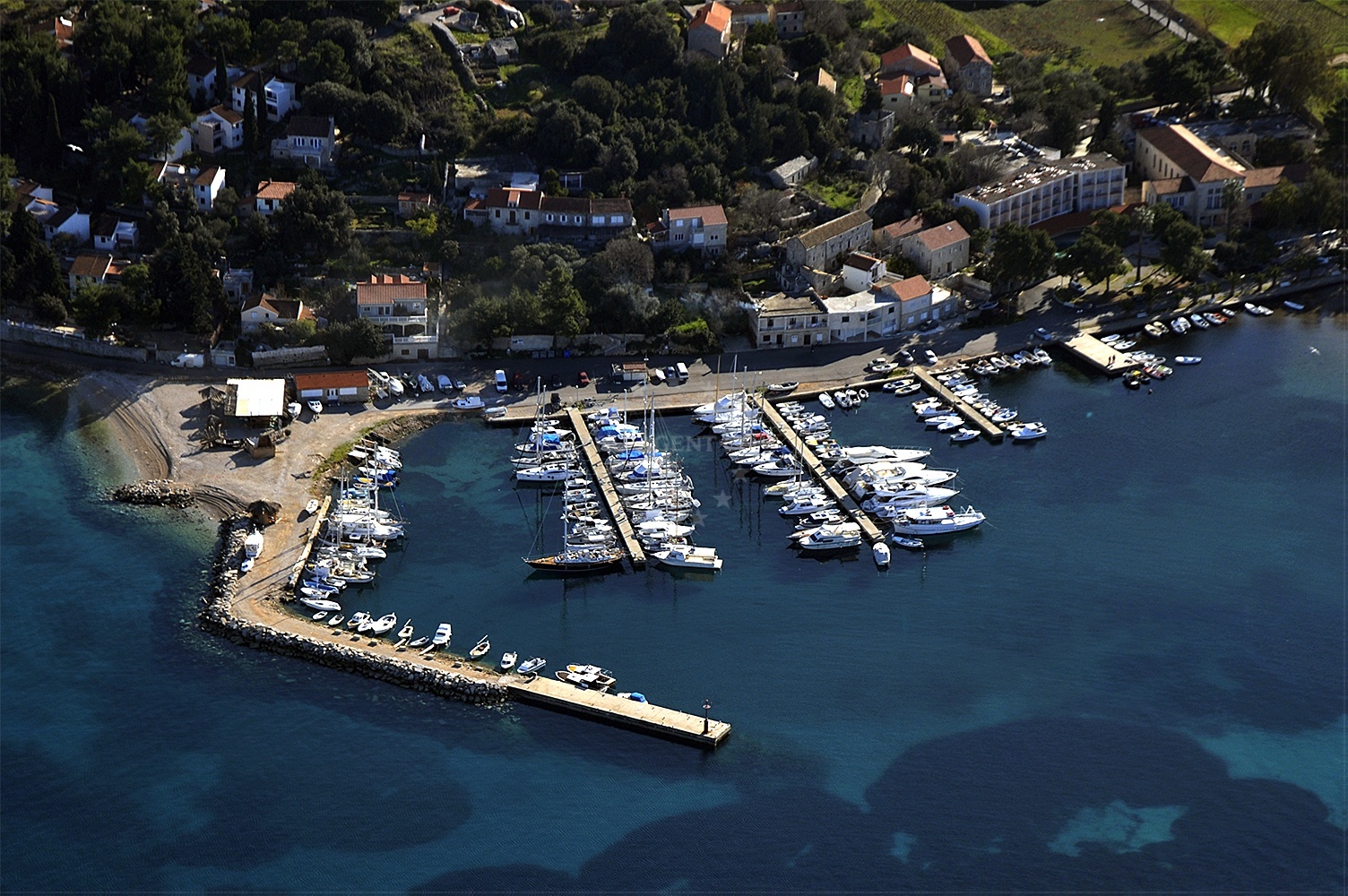 Marina Lumbarda harbor with nearby coastal landscape