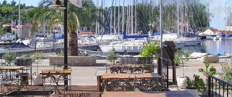 Konoba Dupini terrace overlooking Milna's promenade, Brač, Croatia