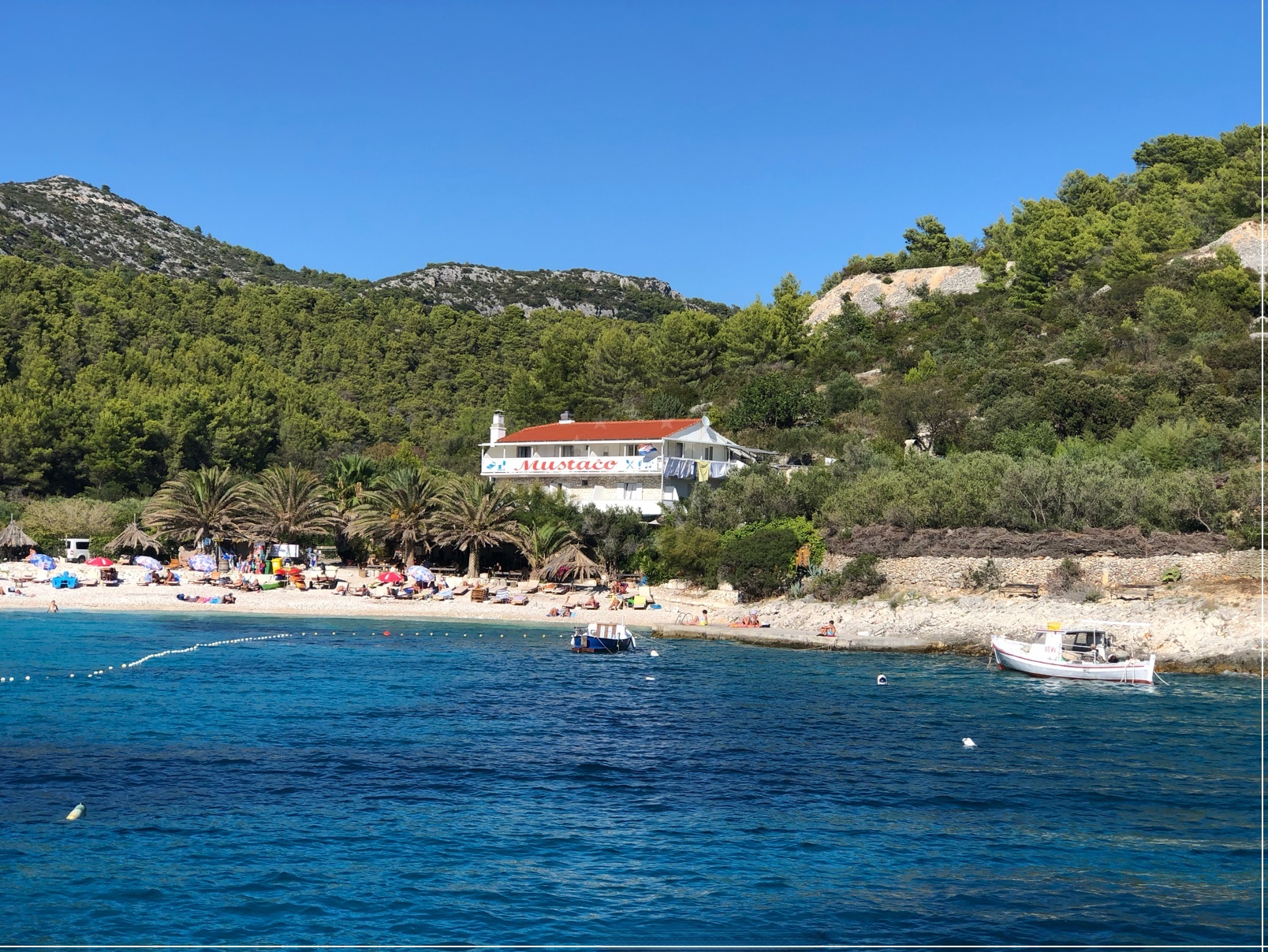 Mustaco Restaurant in Hvar, Central Dalmatia, Croatia, overlooking the Adriatic Sea with nearby marina and beach views