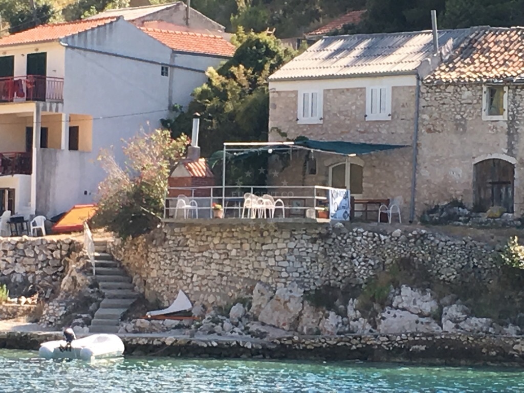 Outdoor dining area at Konoba Dalmatia, overlooking the sea
