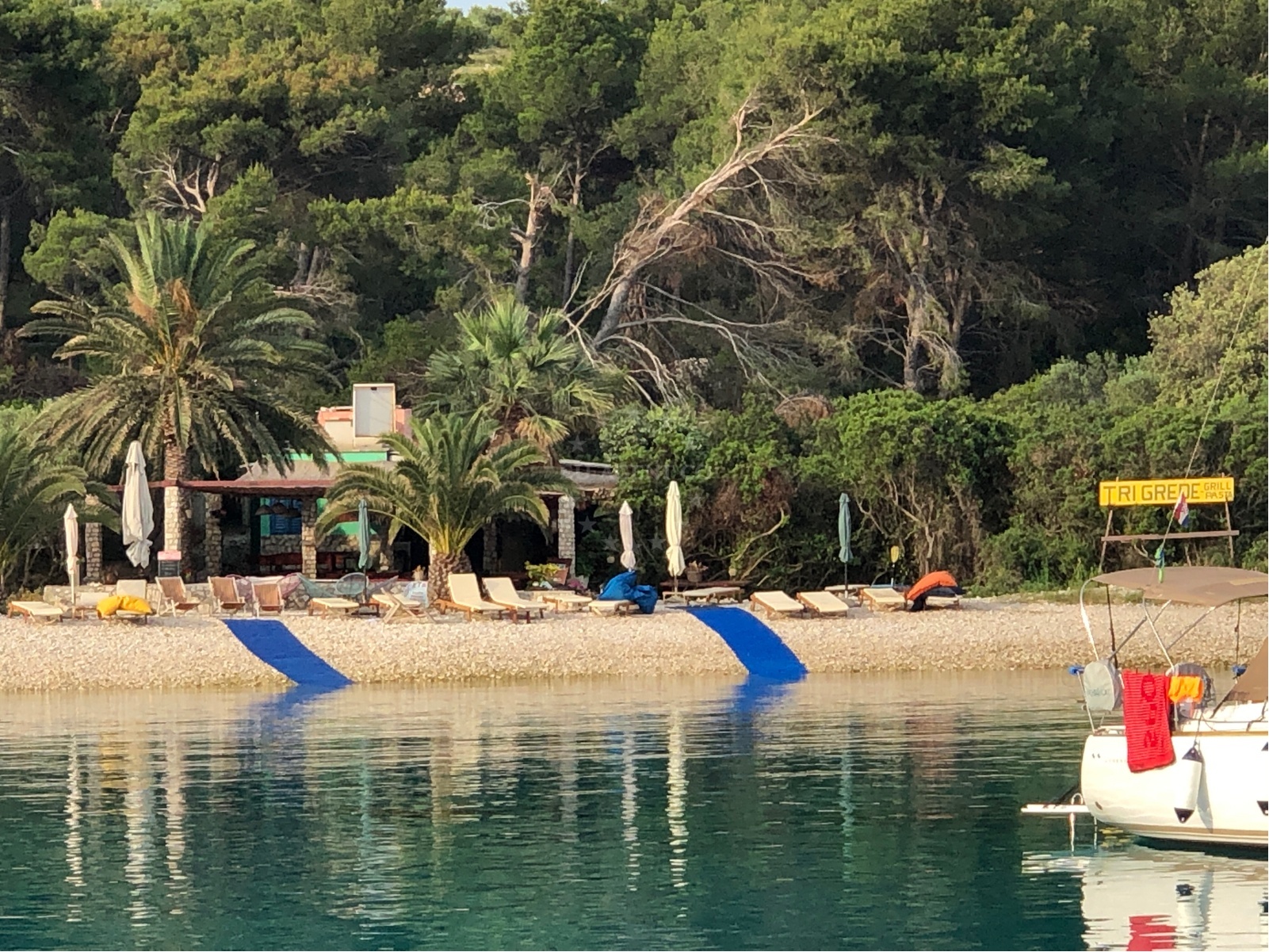 Dining area at Konoba Tri Grede with a view of the surrounding waters