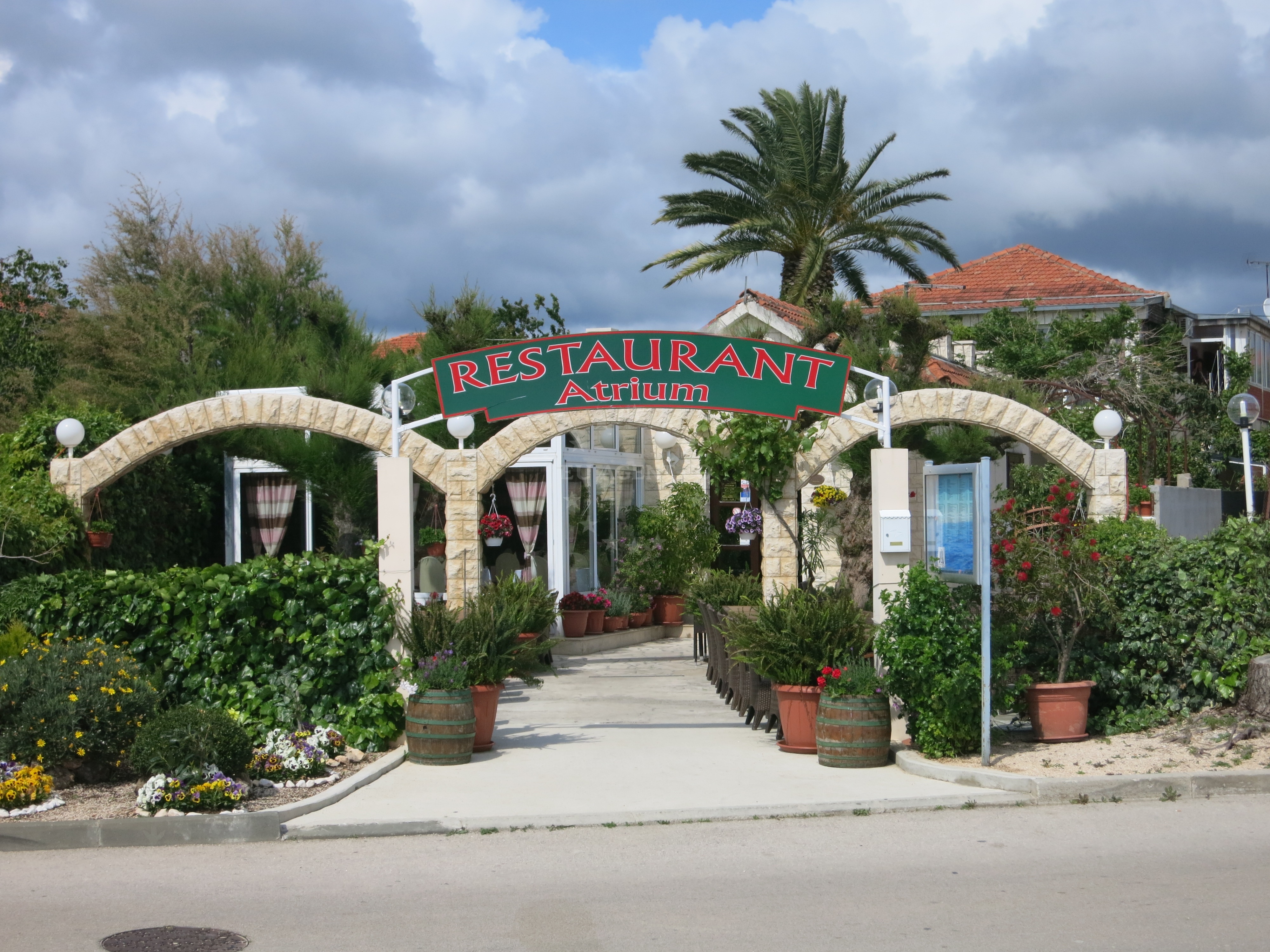 Atrium Restaurant in Rogoznica, Central Dalmatia, Croatia, overlooking the Adriatic Sea with nearby marina and coastline.