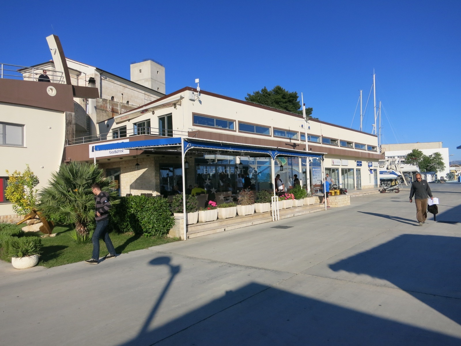 Blue Frog Restaurant in Šibenik, Central Dalmatia, Croatia, overlooking the Adriatic Sea with nearby Marina Mandalina in the distance.