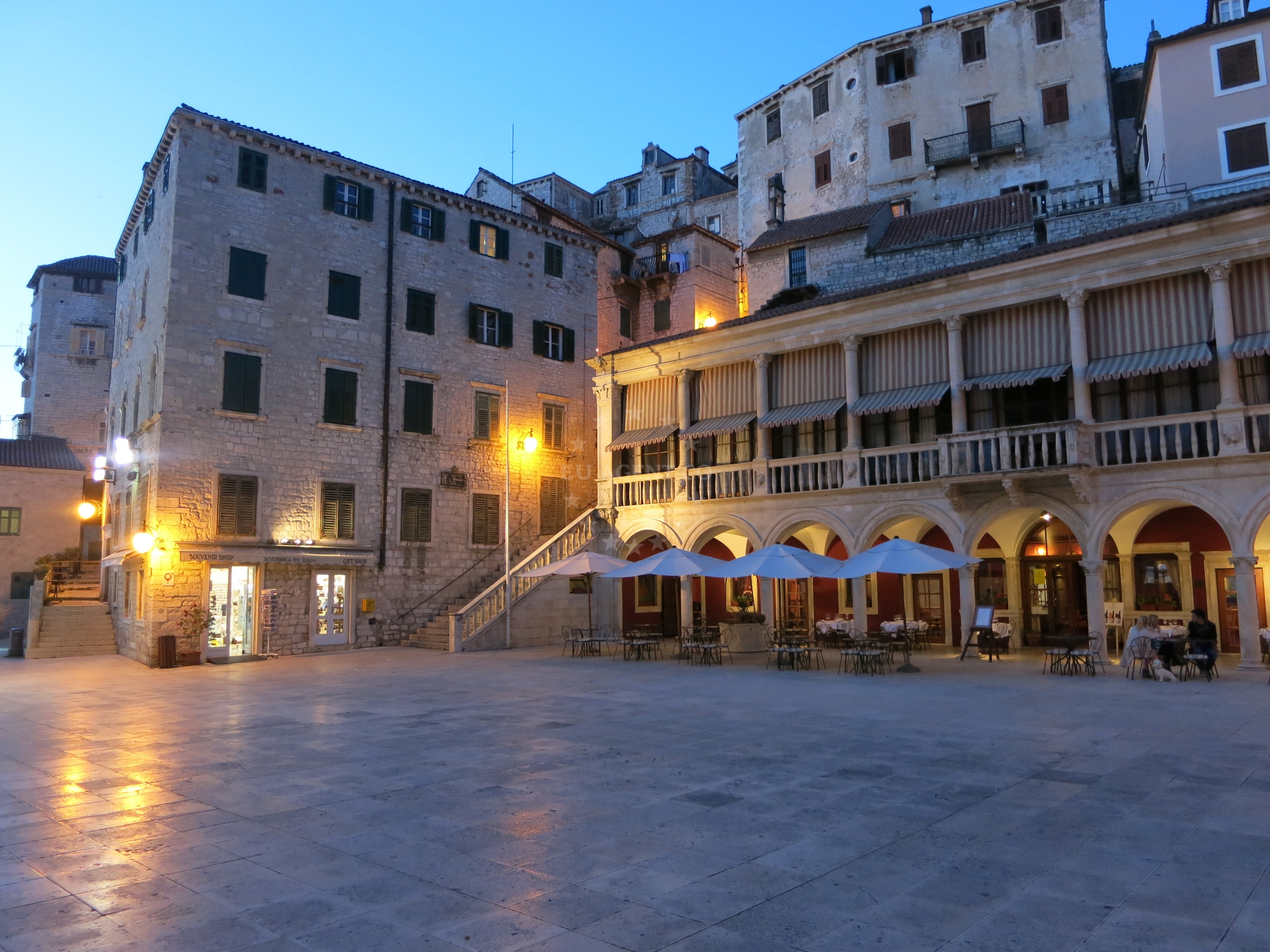Interior dining area at Vijecnica Restaurant with views of Šibenik's historic skyline