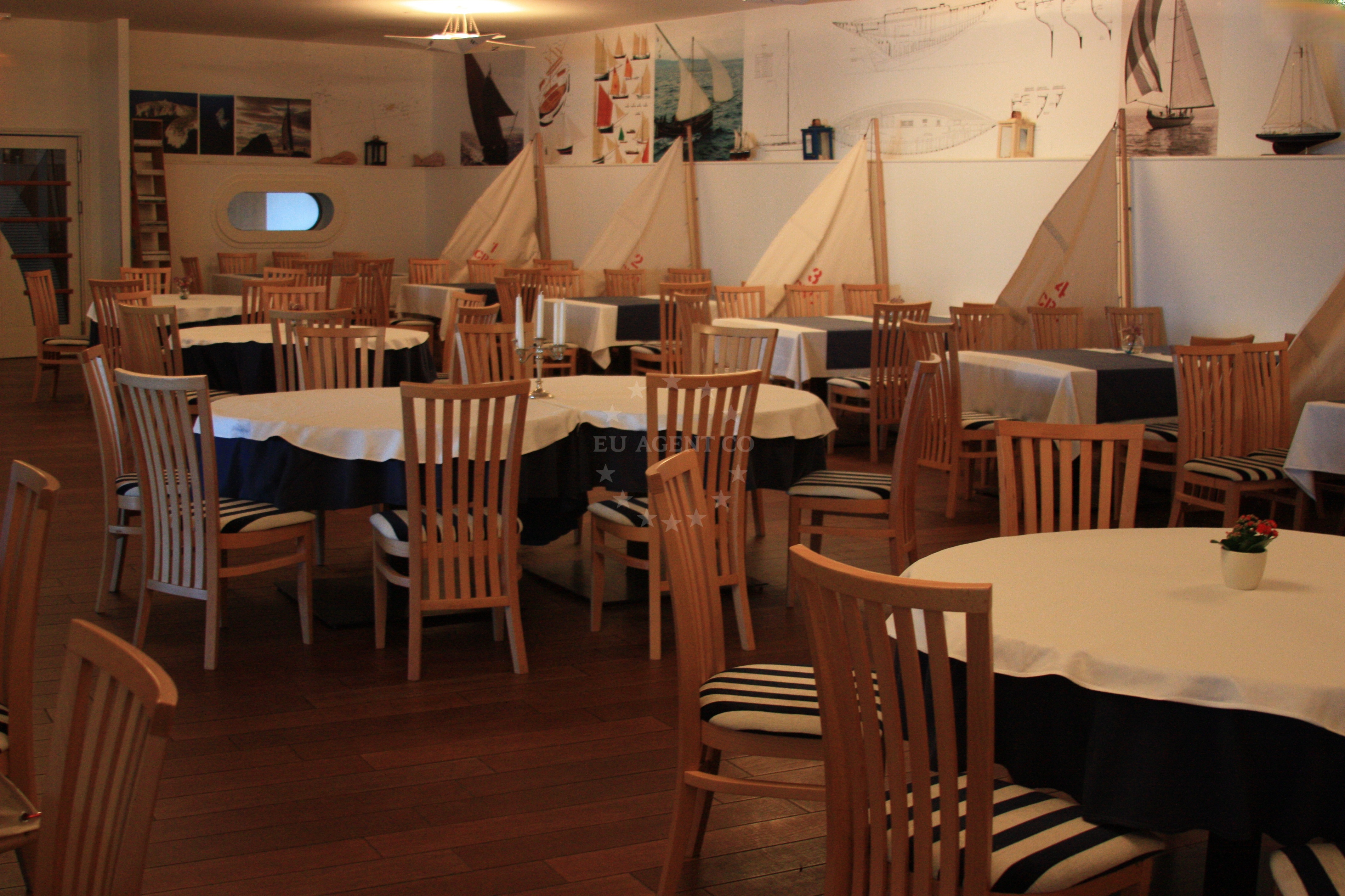 Velum Restaurant in Split, Croatia, overlooking the harbor with tables under umbrellas.