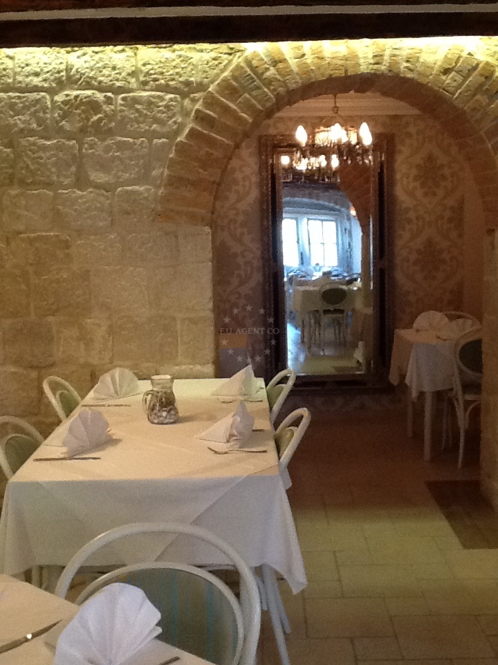 Dining table with tartar beef and grilled fish at Alka Restaurant