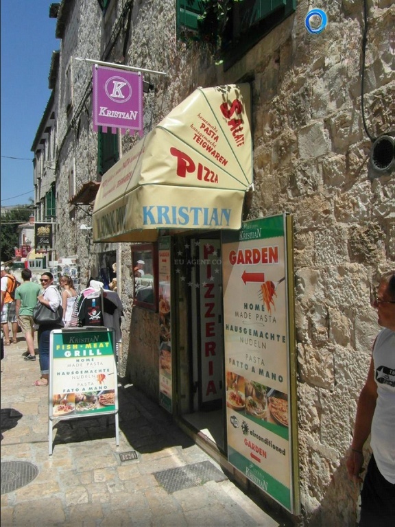 Pizzeria Kristian's interior with views of Trogir's historic architecture