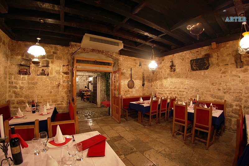 Dining area at Tragos Restaurant with views of Trogir's historic architecture