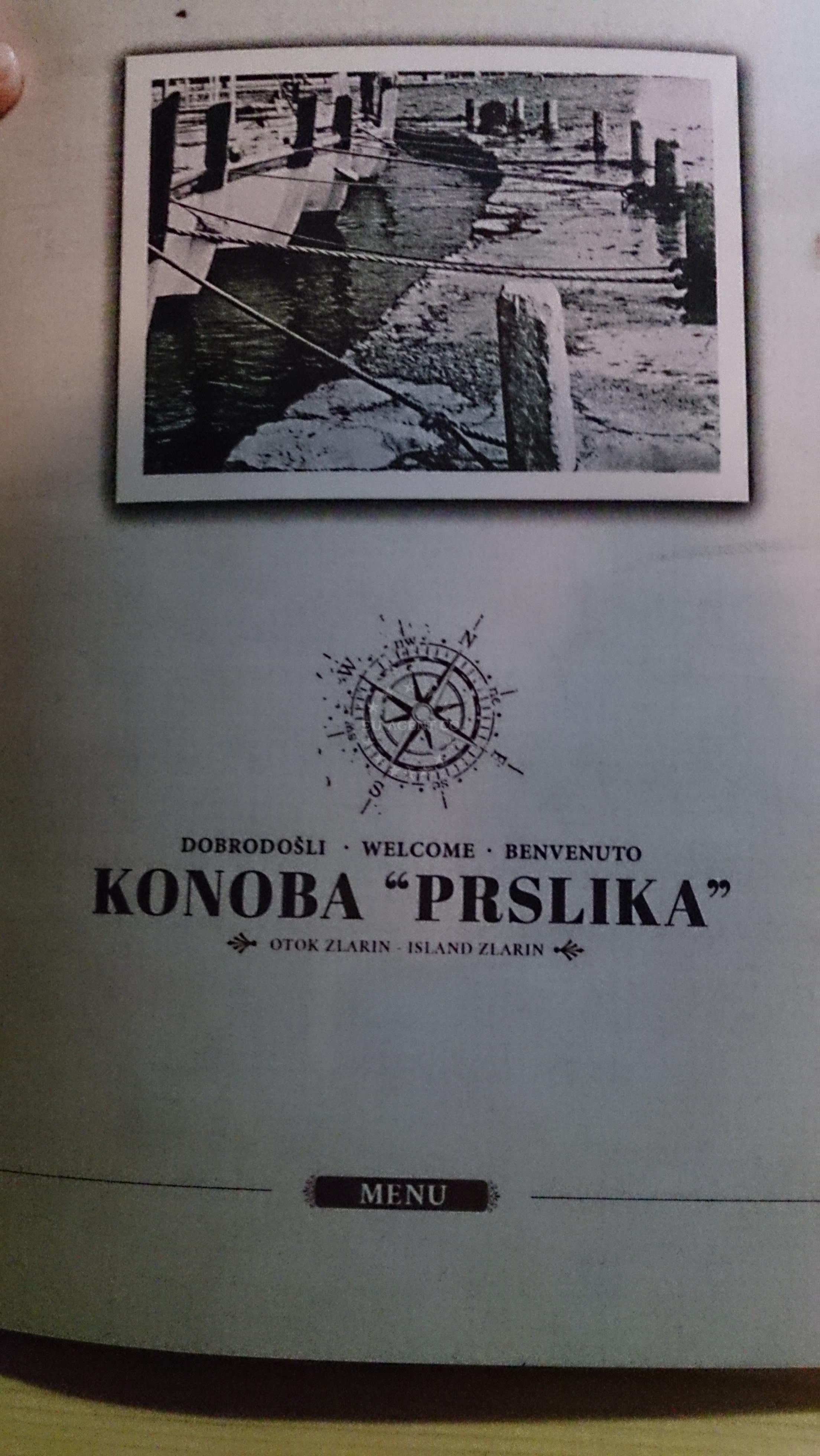 Interior of Konoba Prslika, showcasing traditional Dalmatian decor and a family-friendly atmosphere