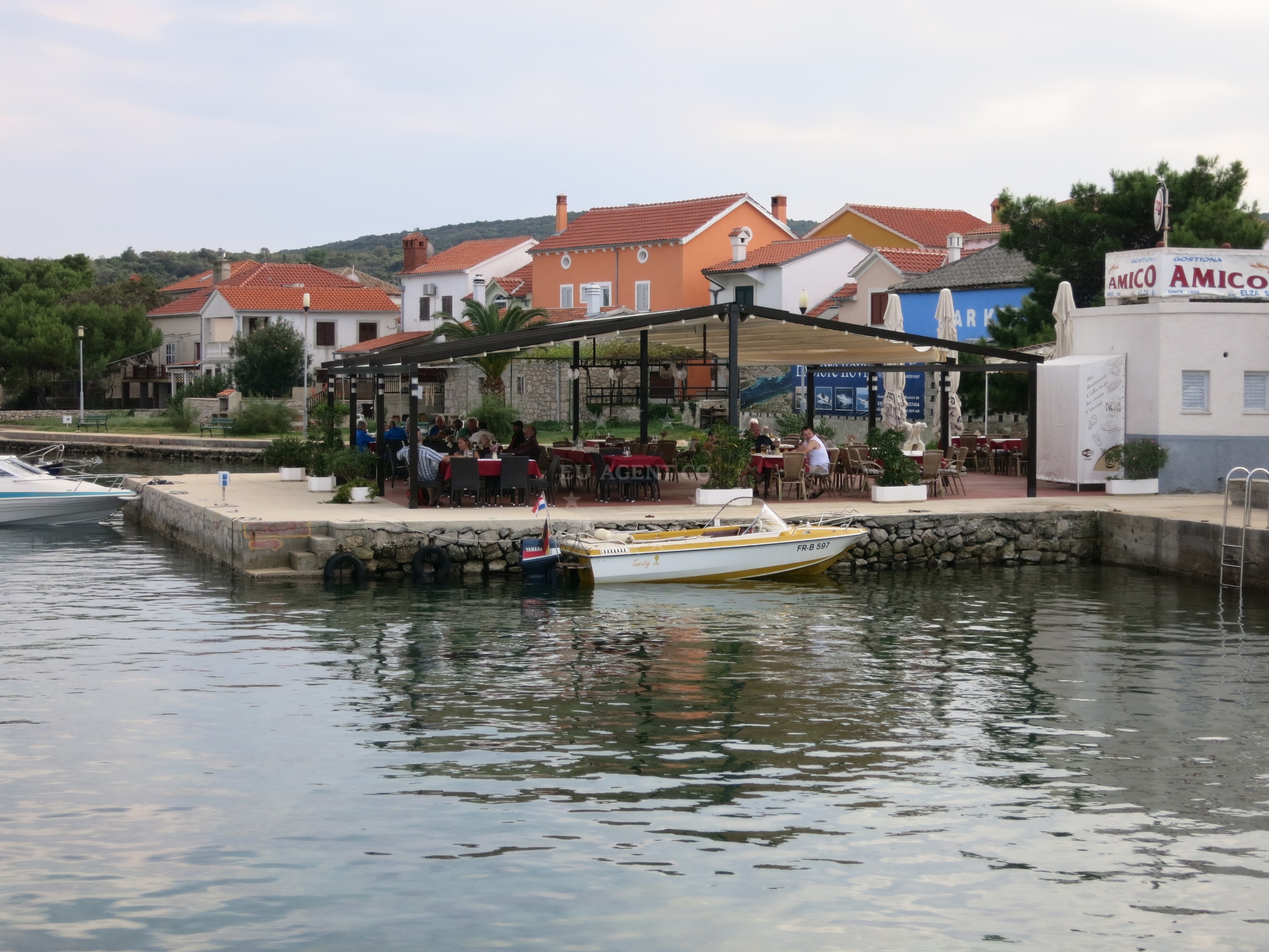 Dining area at Amico Restaurant with views of Harbour Ilovik, Croatia