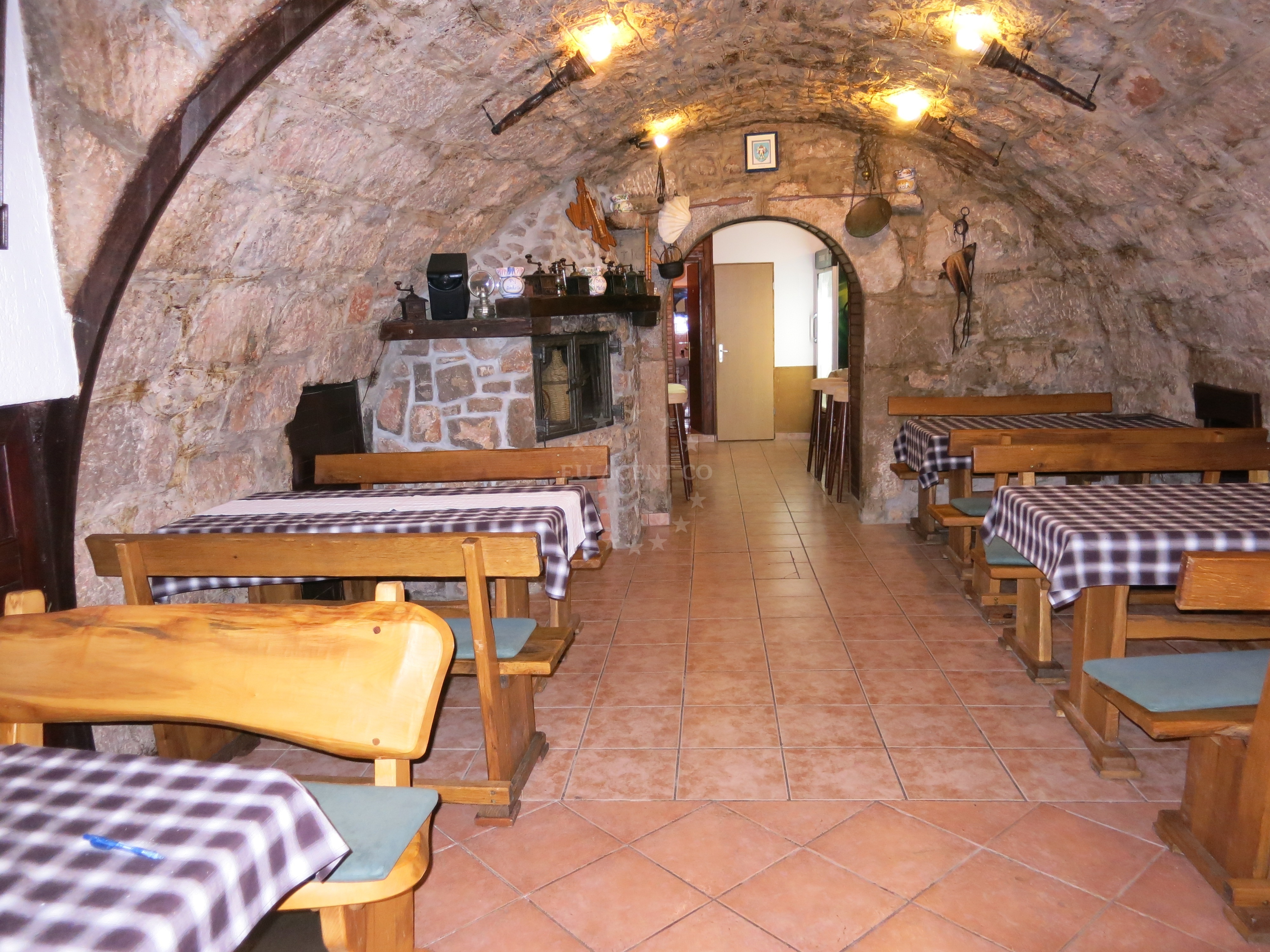 Interior view of Konoba Zestic with rustic decor and local seafood dishes.
