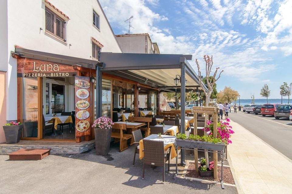 Luna Restaurant's seaside terrace overlooking the Adriatic Sea in Novigrad Istarski, Croatia